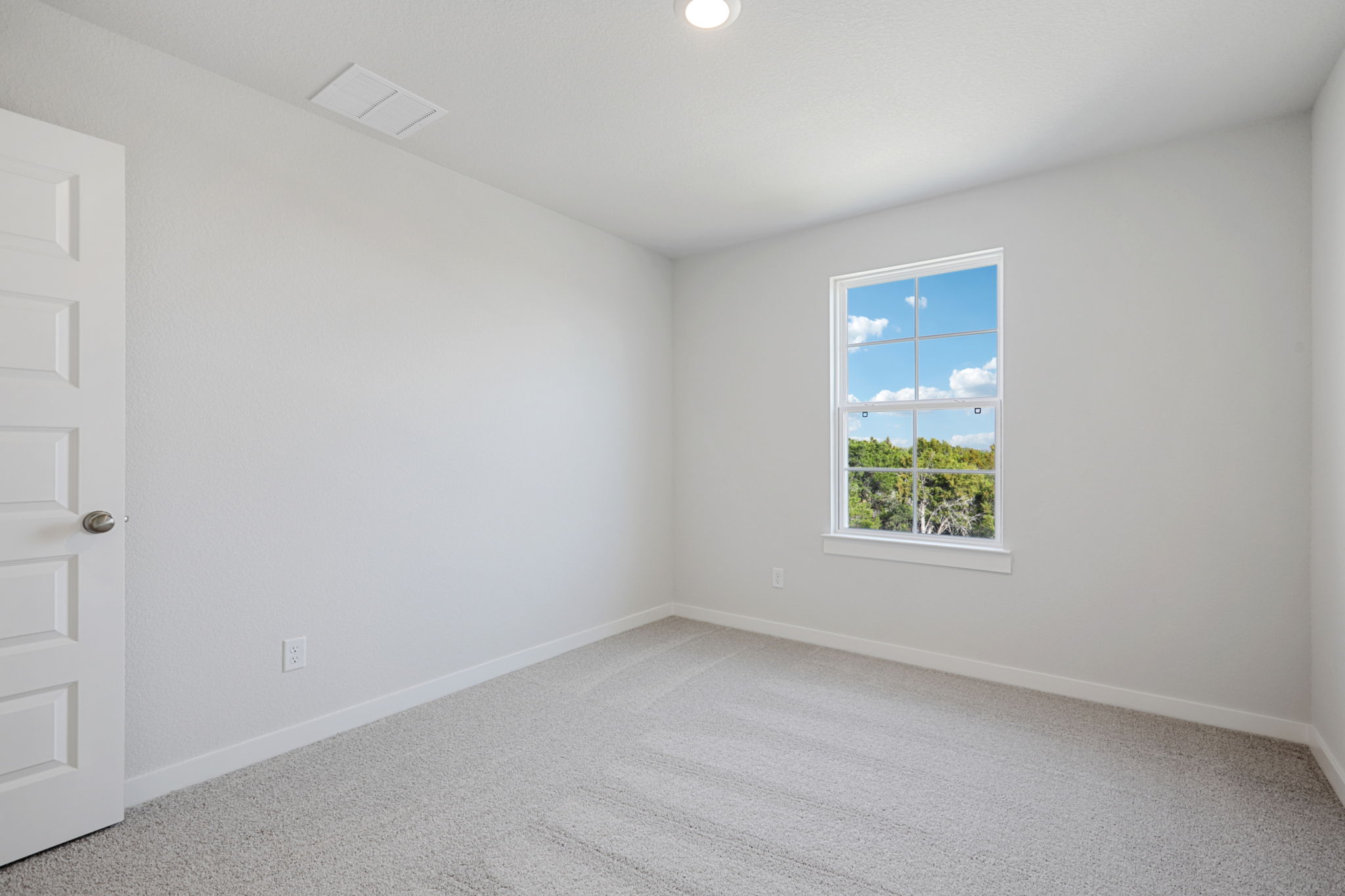 A room with a window and a door.