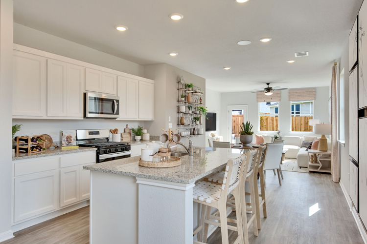 A kitchen with white cabinets.