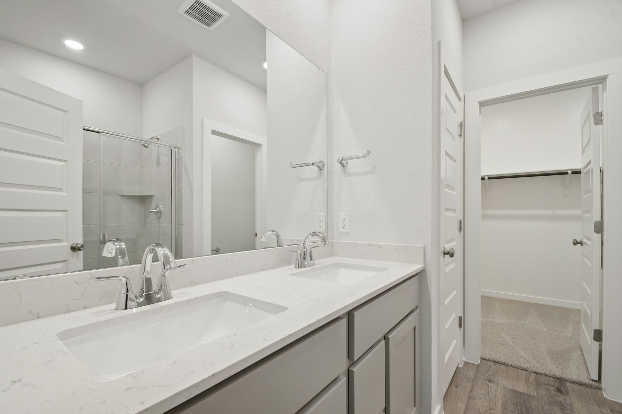 A bathroom with a large mirror.
