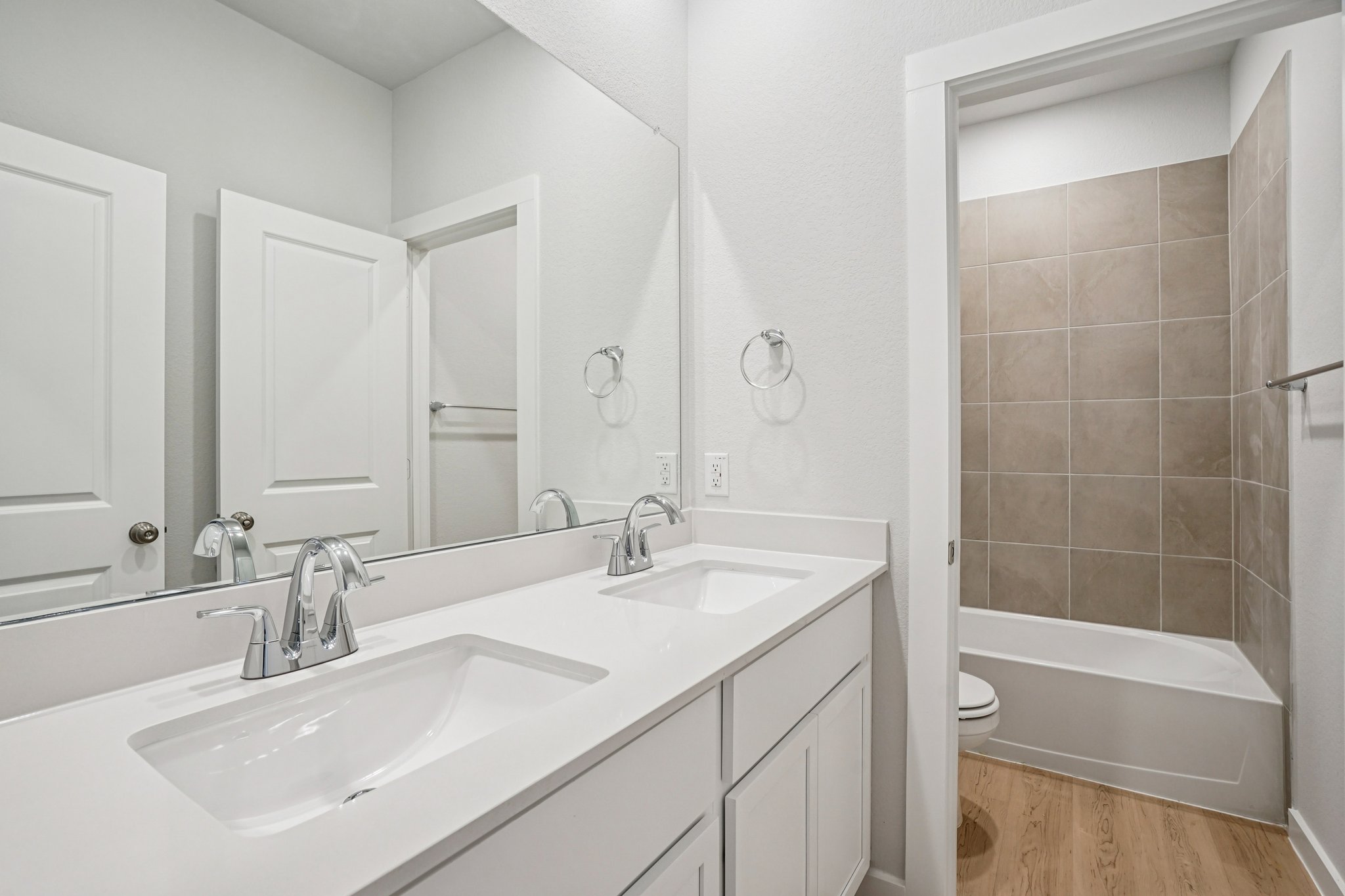 A bathroom with a tub sink and a toilet.