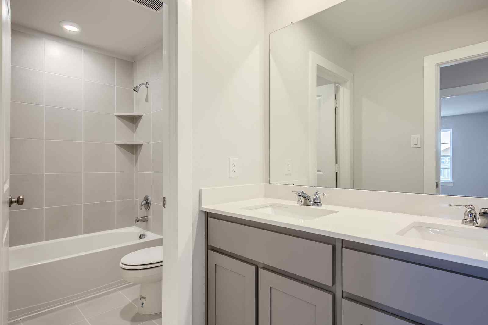 A bathroom with a tub sink and toilet.