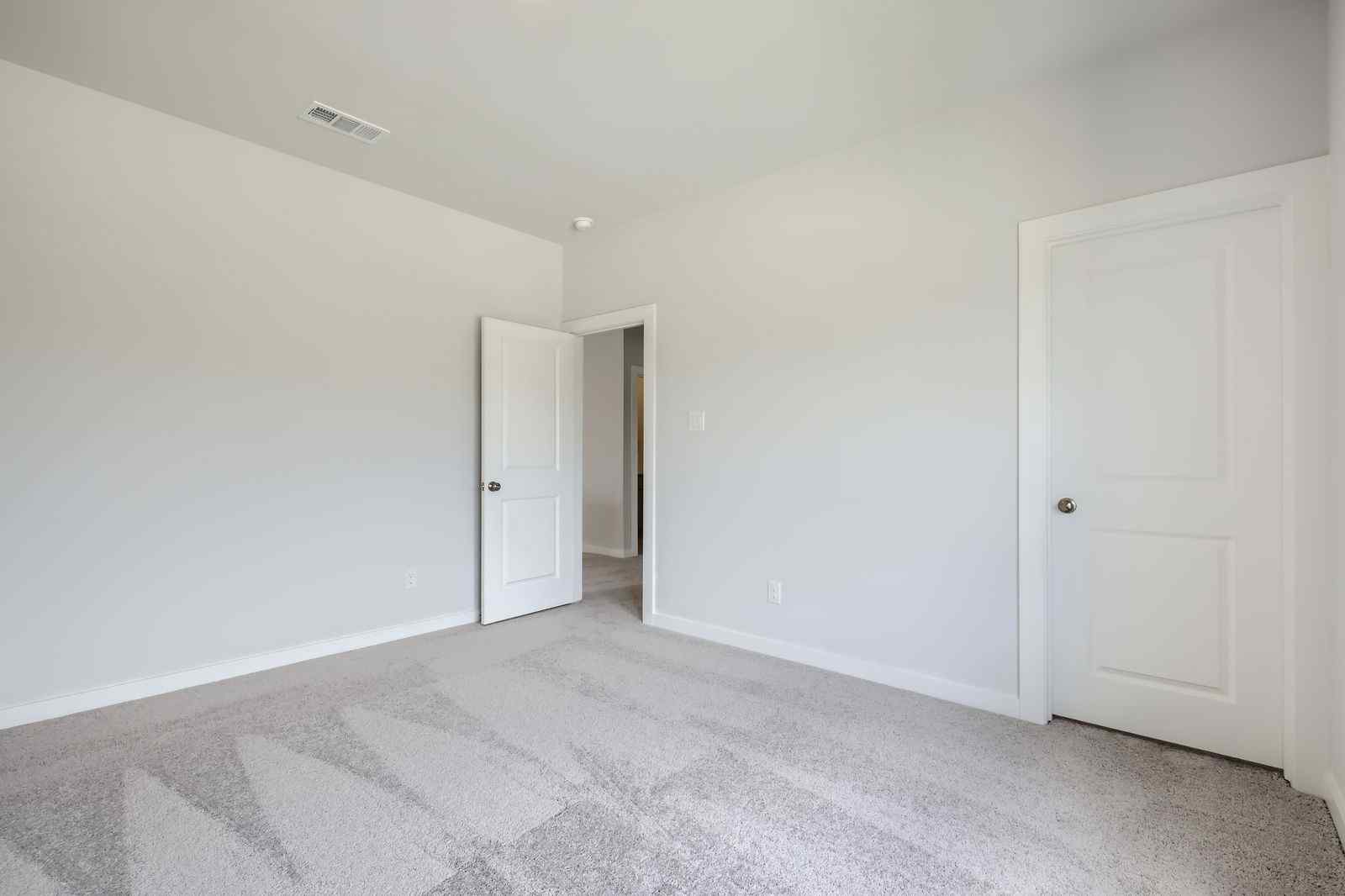 A hallway with white doors.