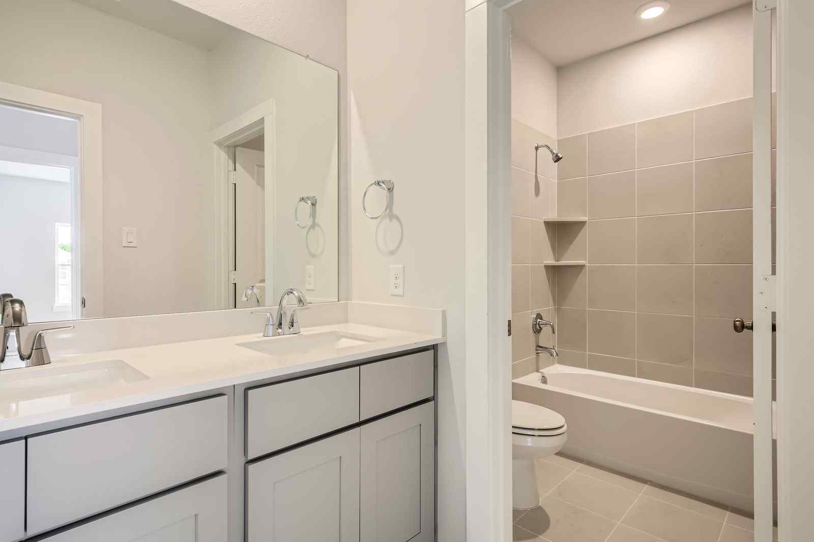A bathroom with a tub sink and toilet.
