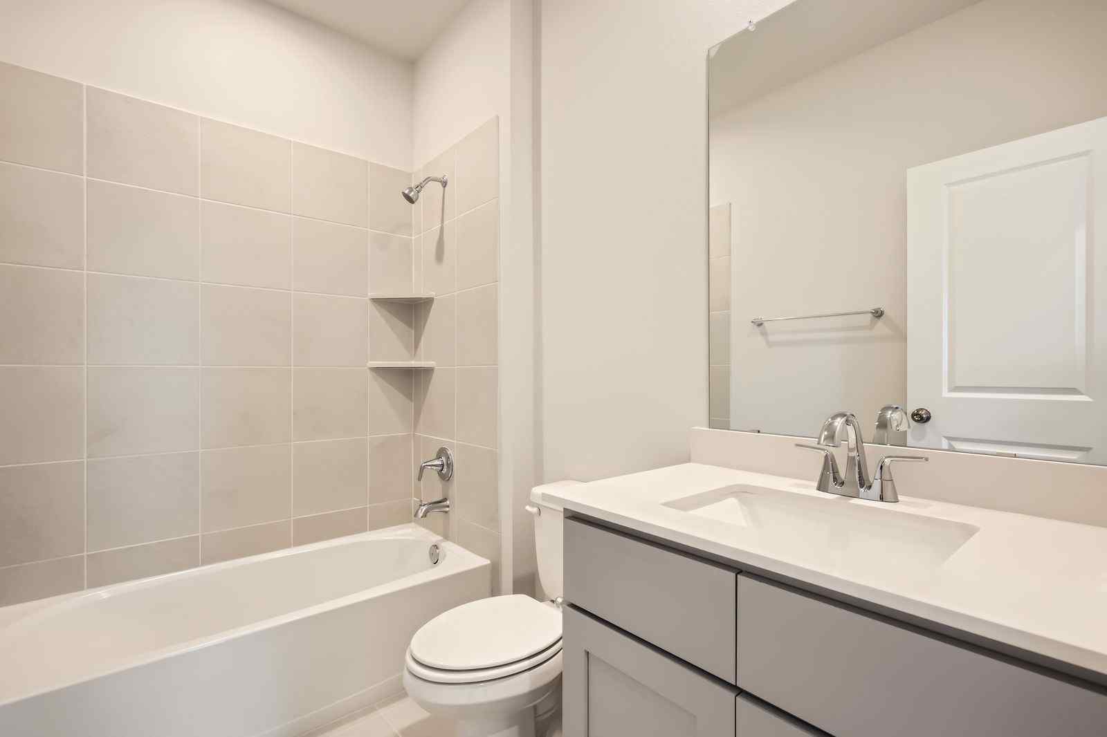 A bathroom with a tub sink and toilet.
