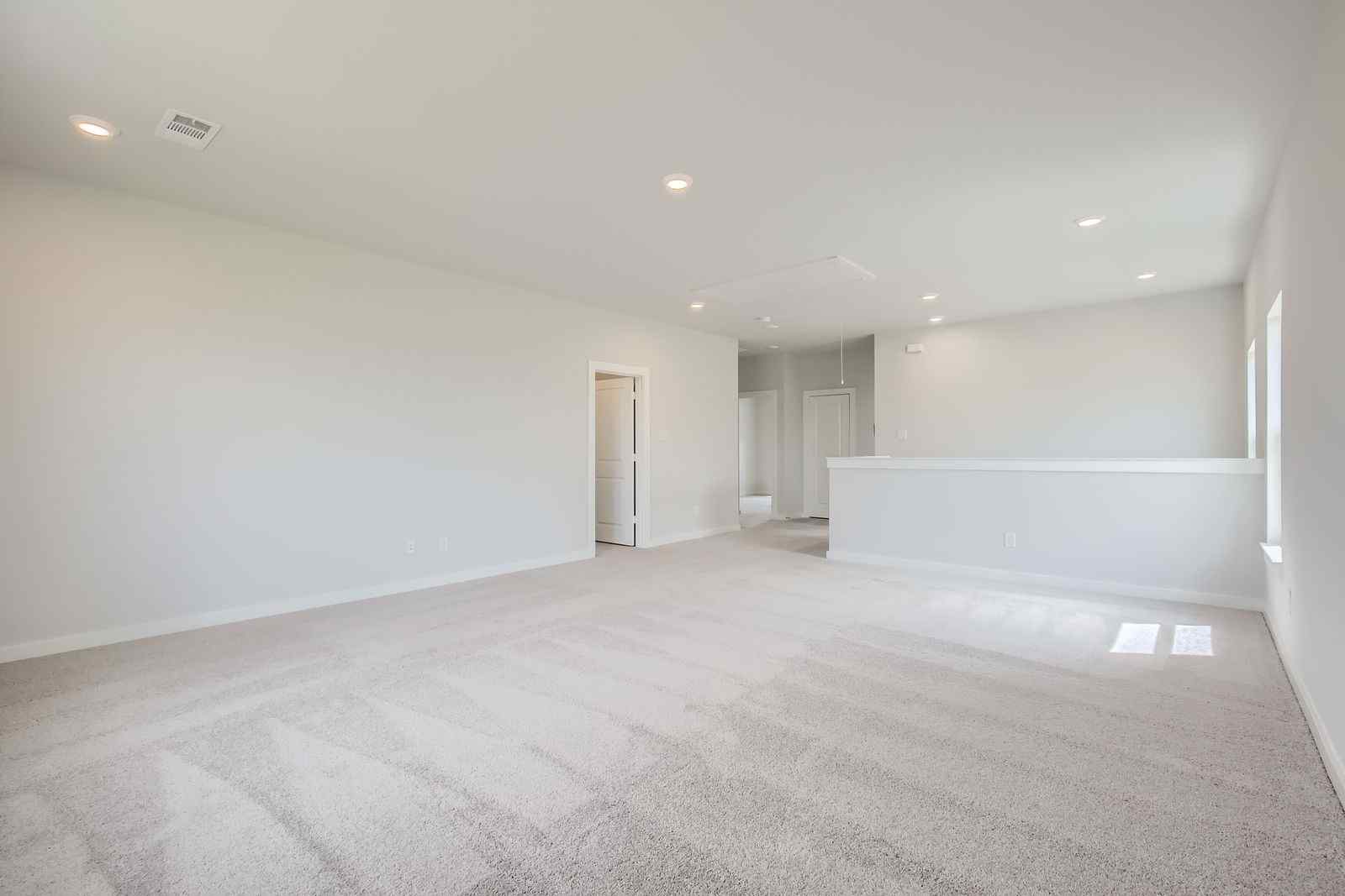 A long hallway with white walls.