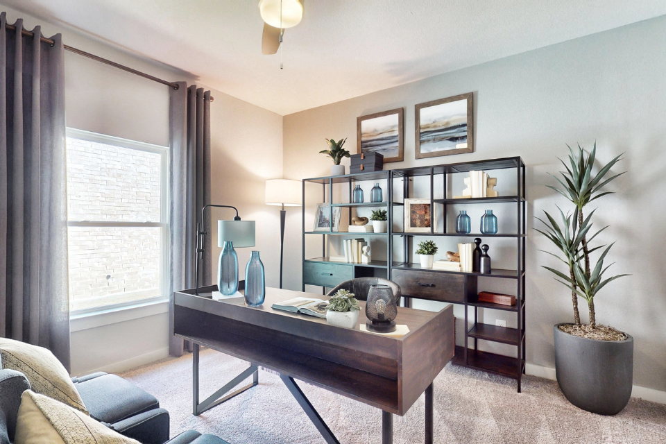 A living room with a table and shelves.