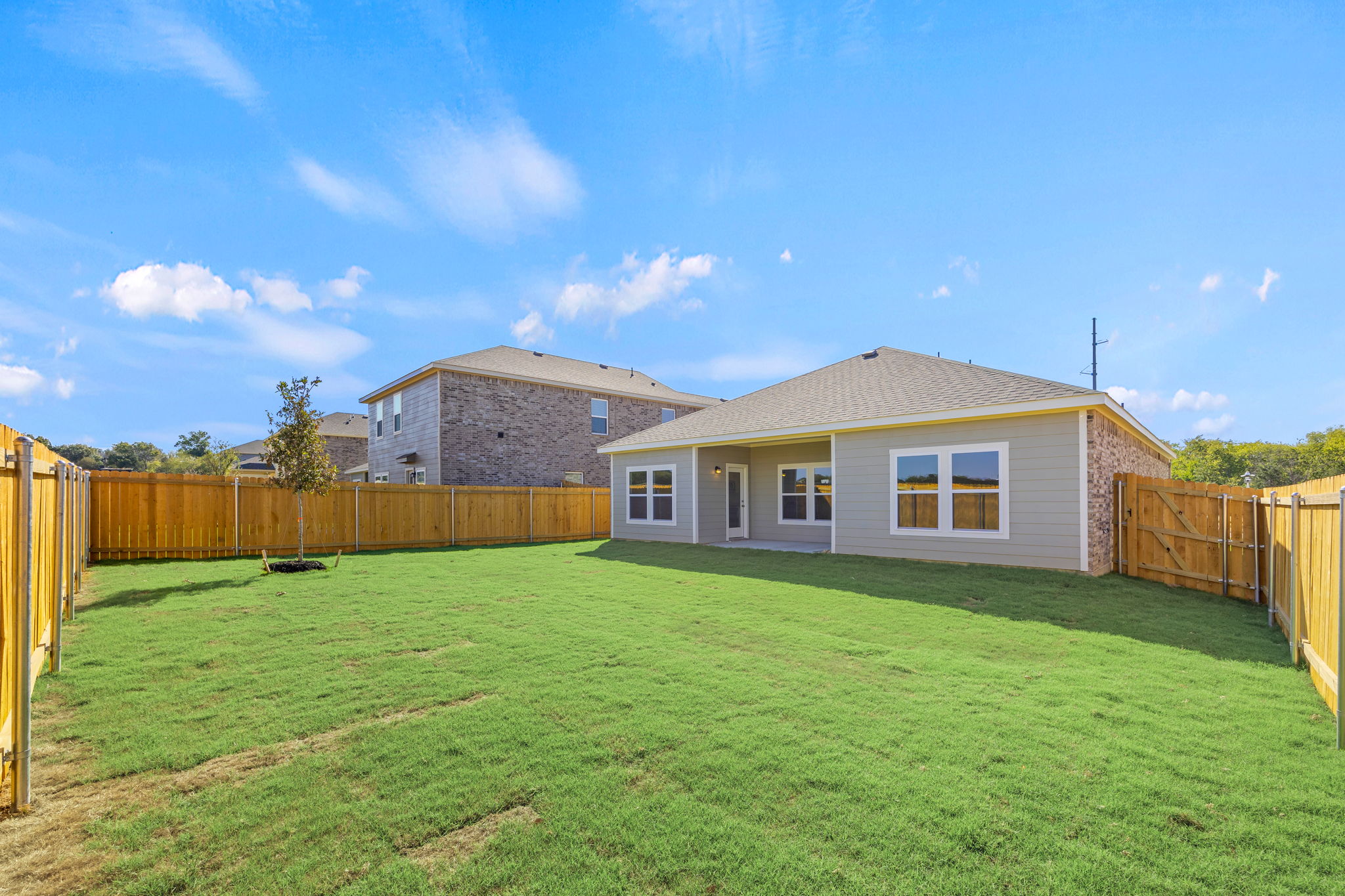 A house with a fence and yard.
