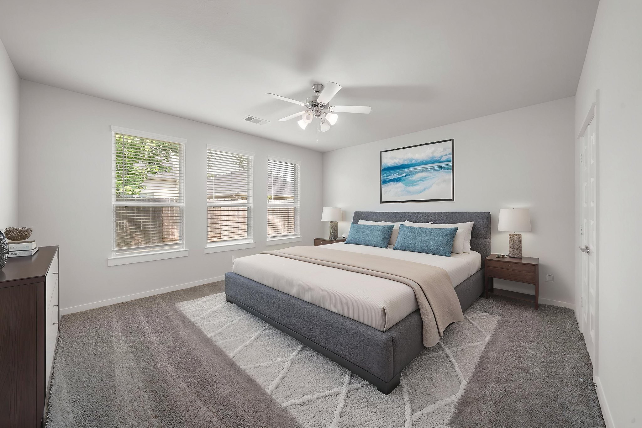 A bedroom with a bed and a fan.