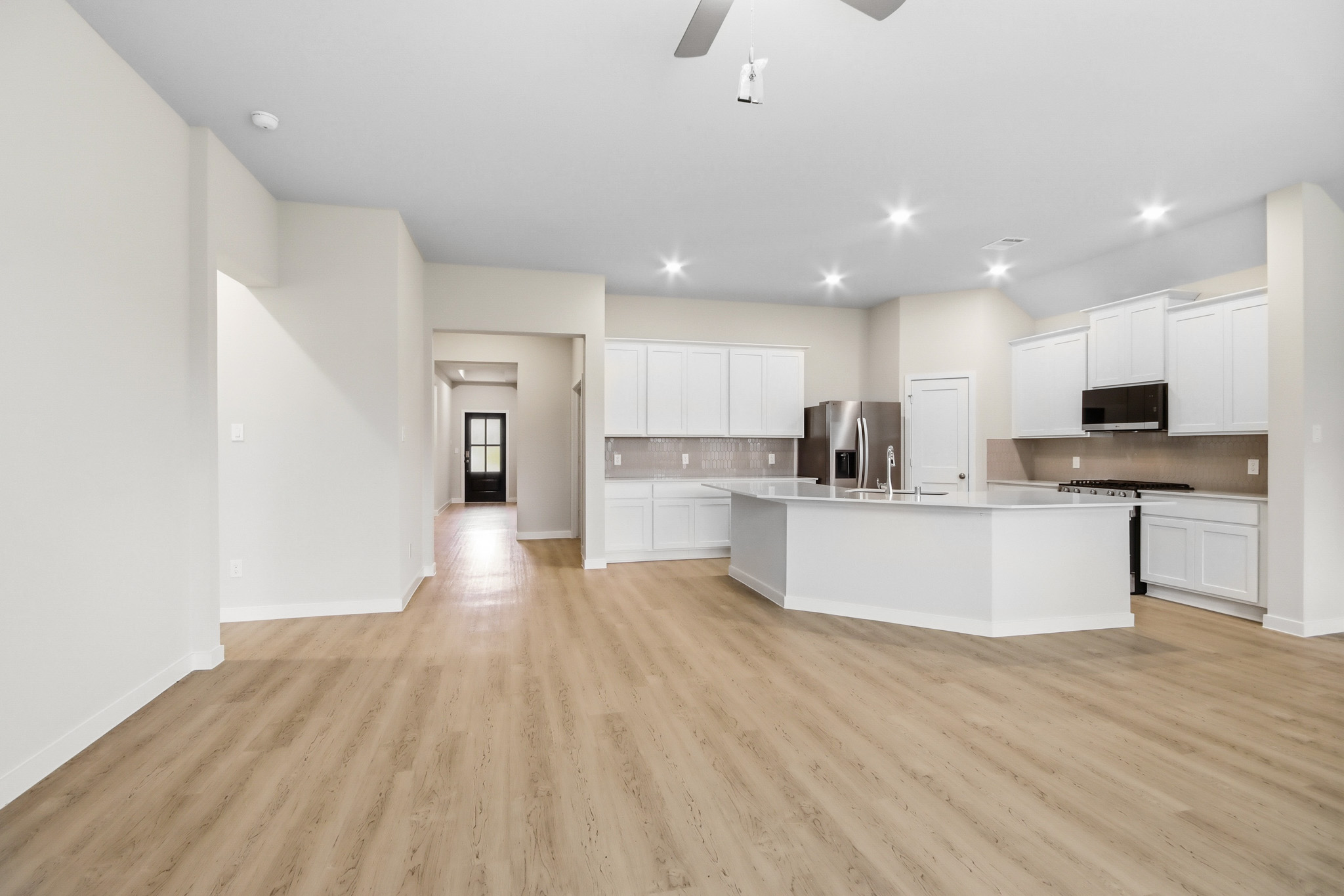 A large kitchen with white cabinets.