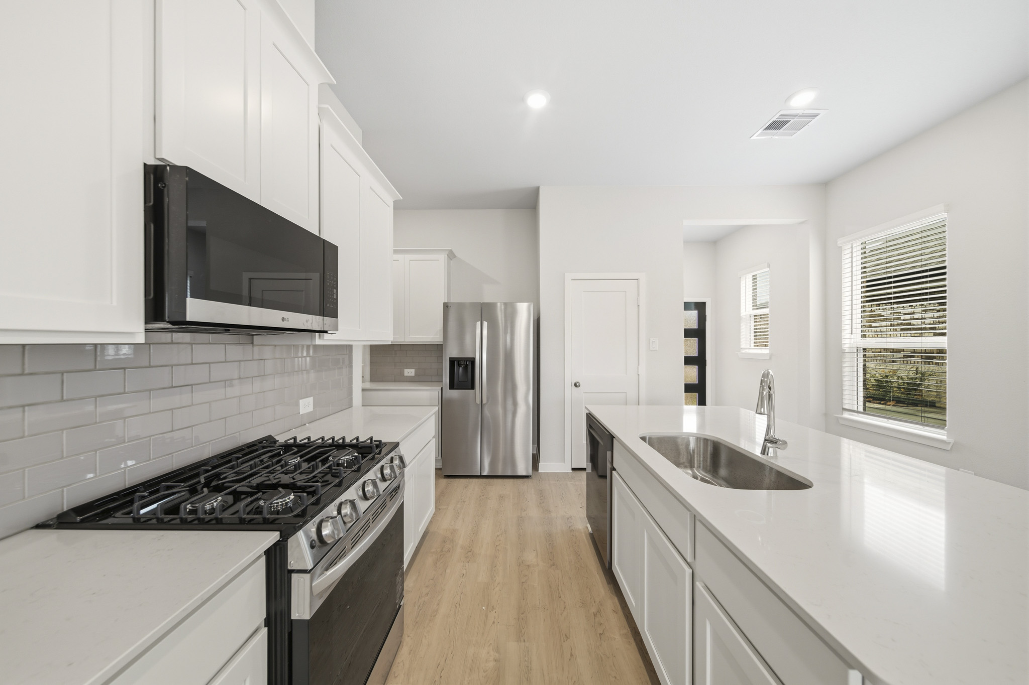 A kitchen with white cabinets.