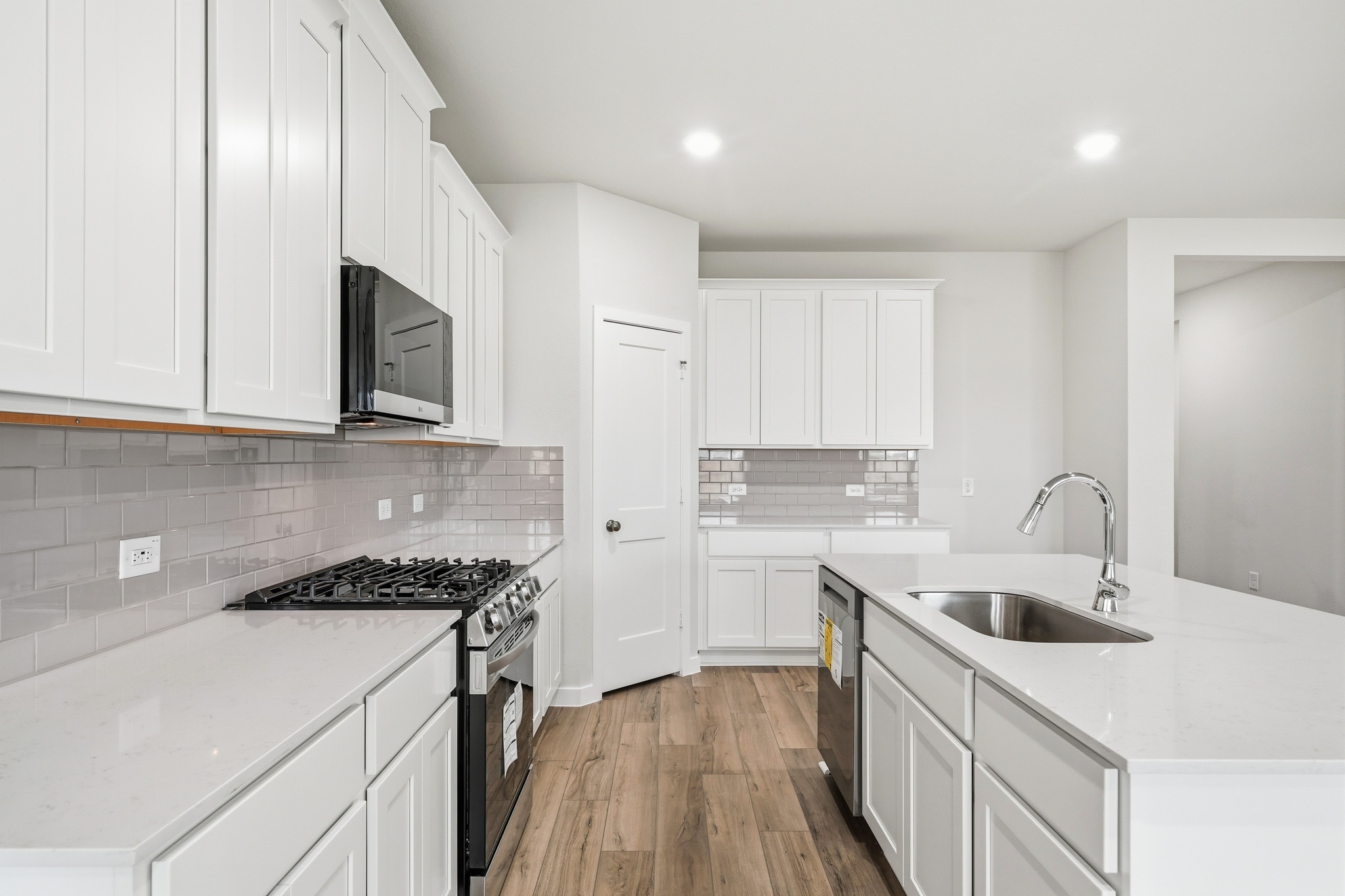 A kitchen with white cabinets.
