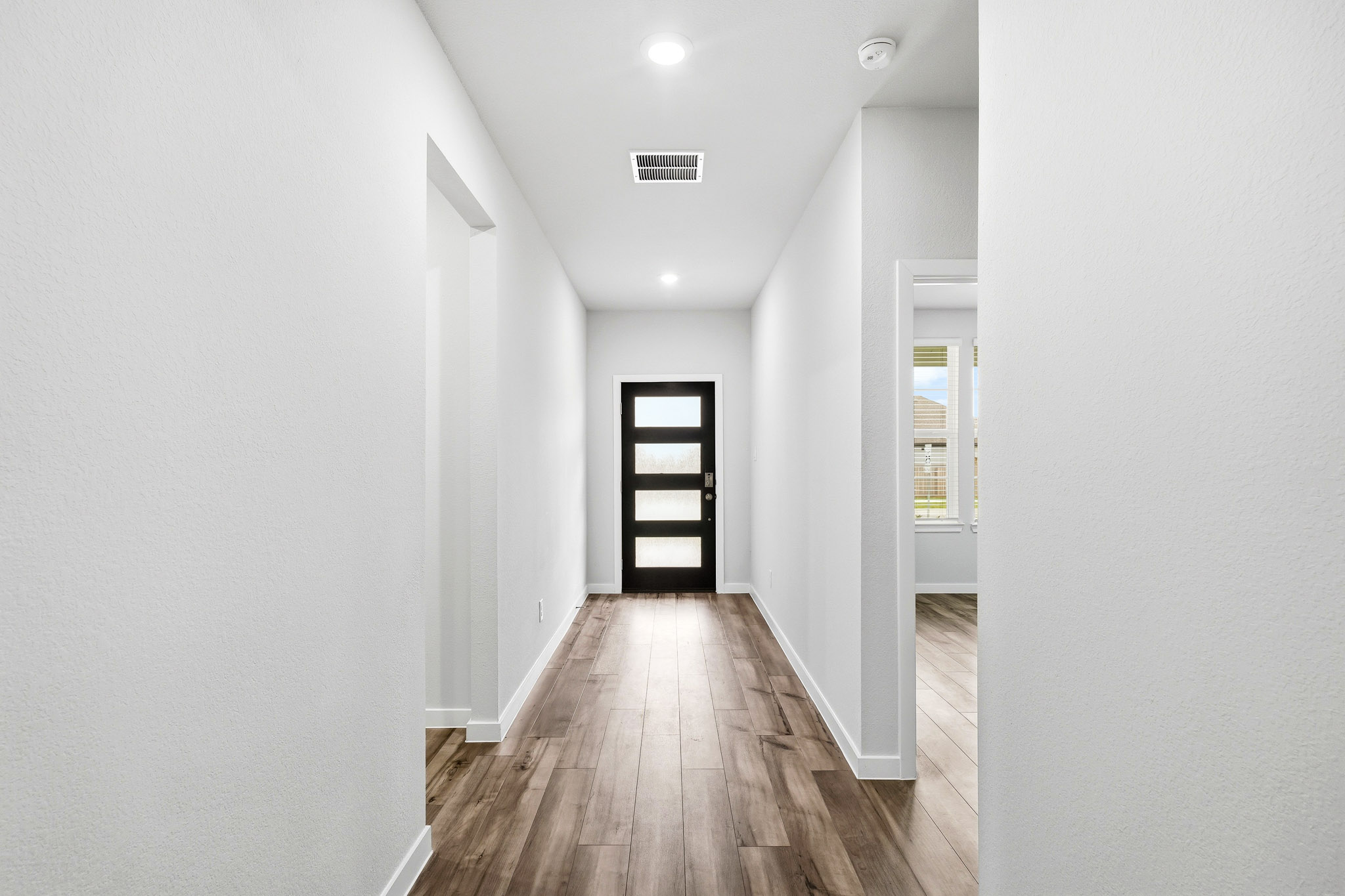 A hallway with white walls.