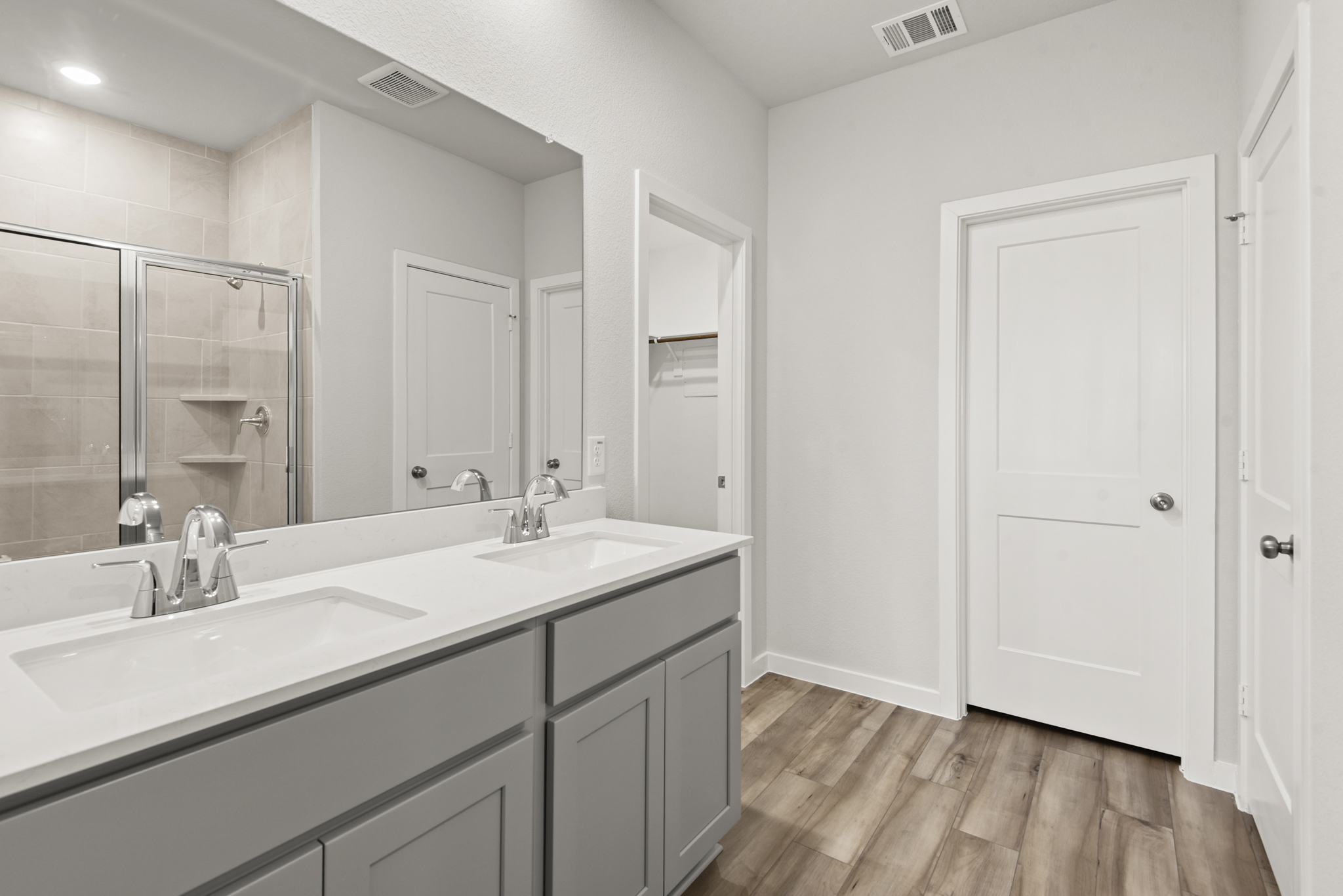 A bathroom with a large mirror.