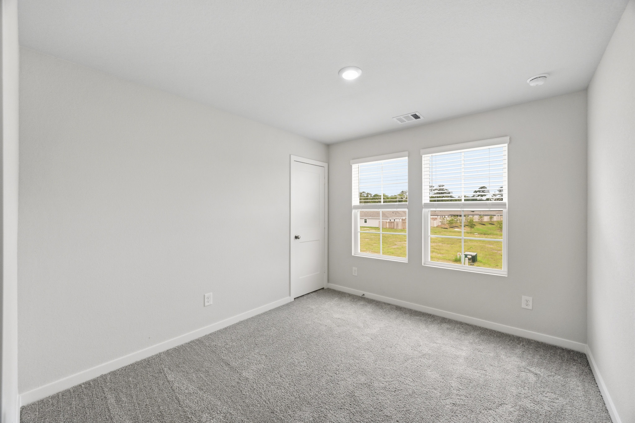 A room with a window and a door.
