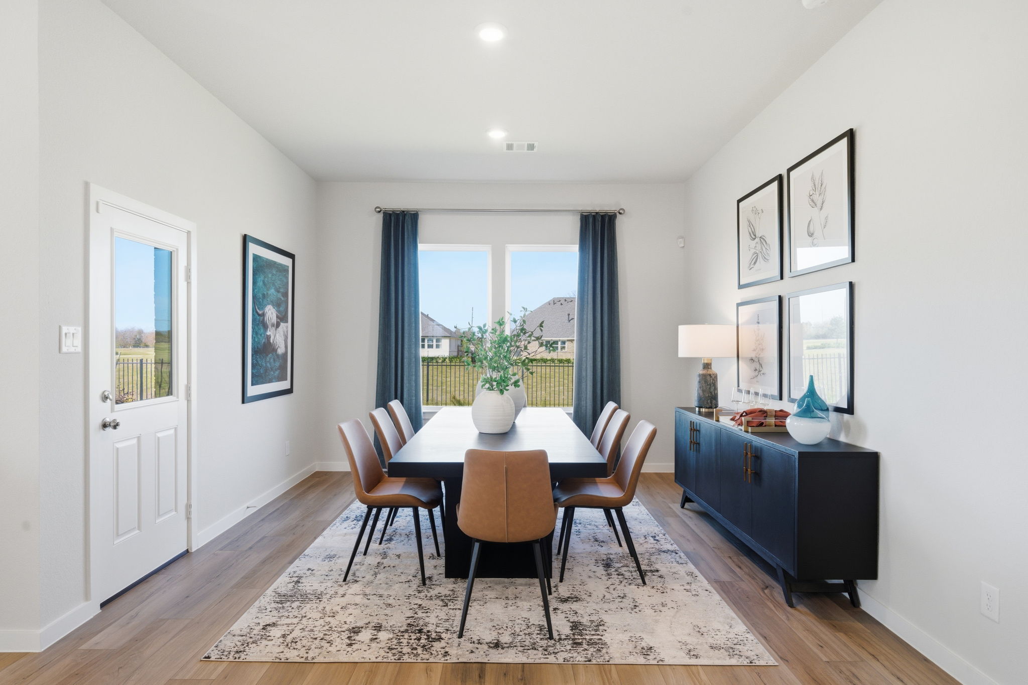 A dining room with a large window.
