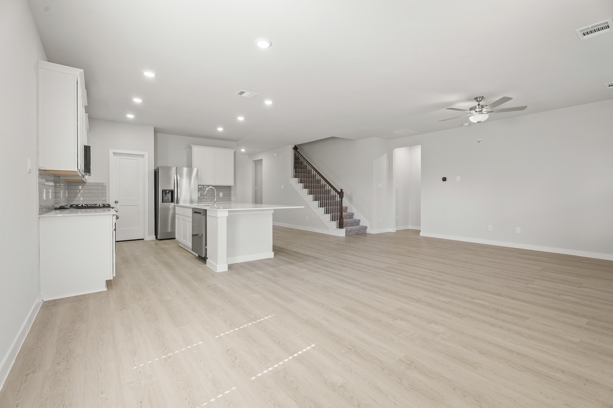 A large kitchen with white cabinets.