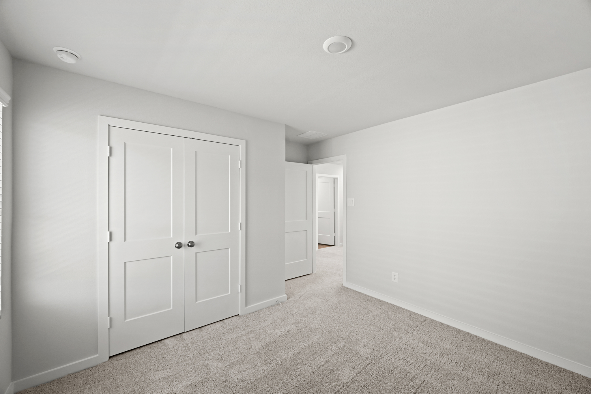 A hallway with white doors.