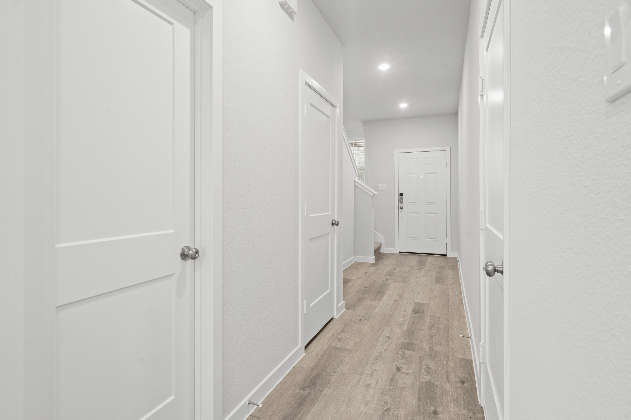 A hallway with white doors.