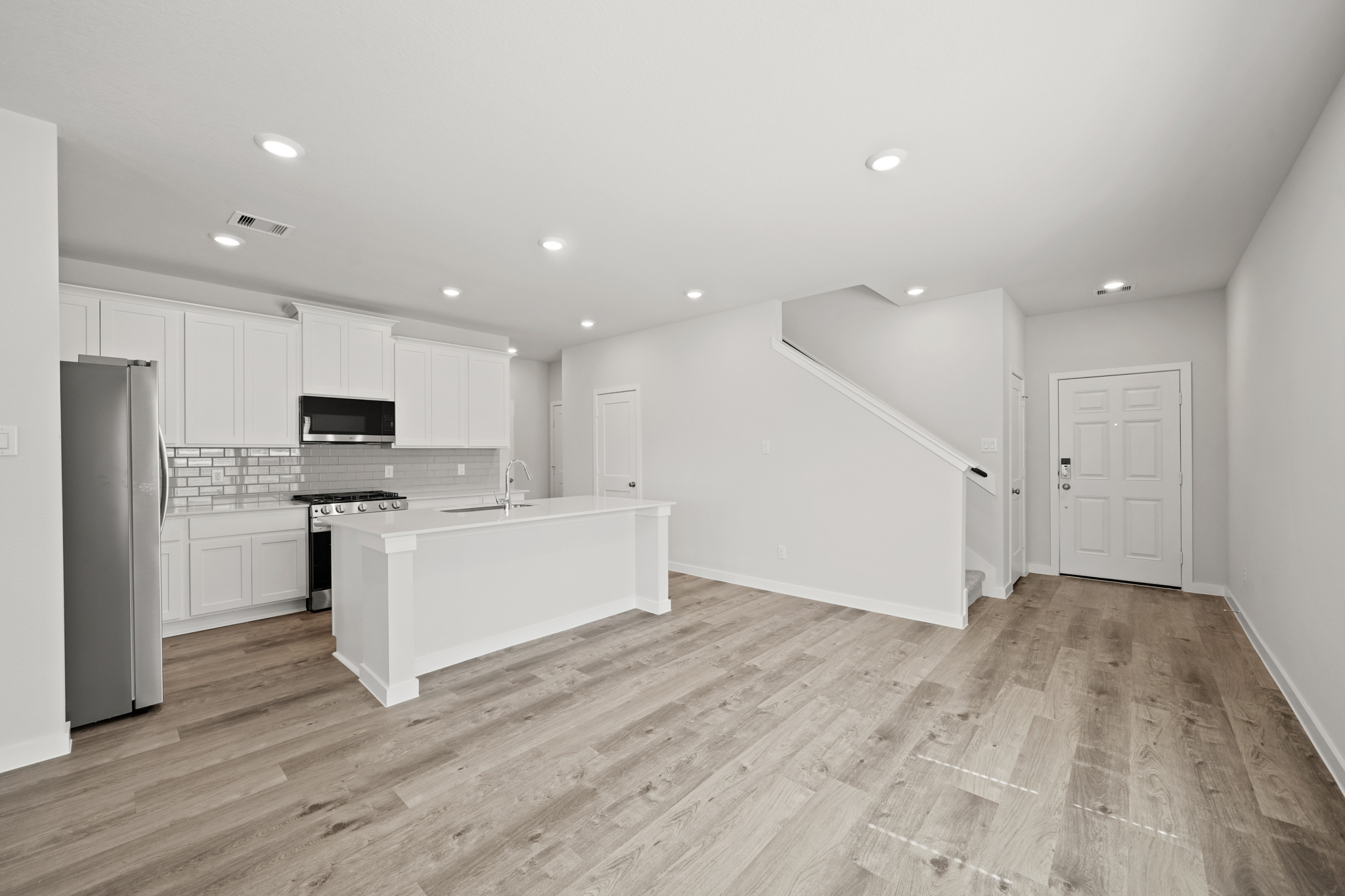A kitchen with white cabinets.