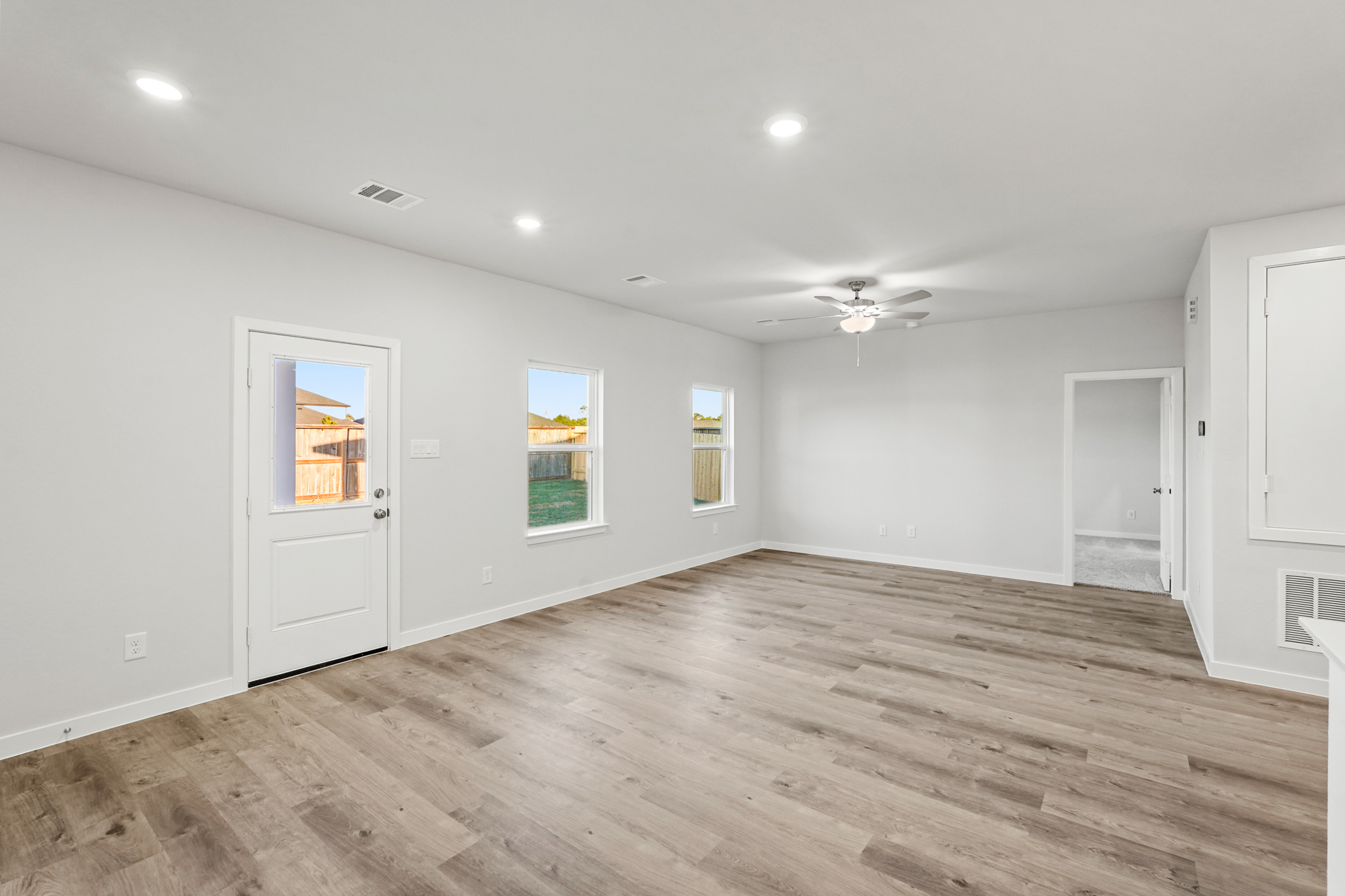 A room with white walls and a wood floor.