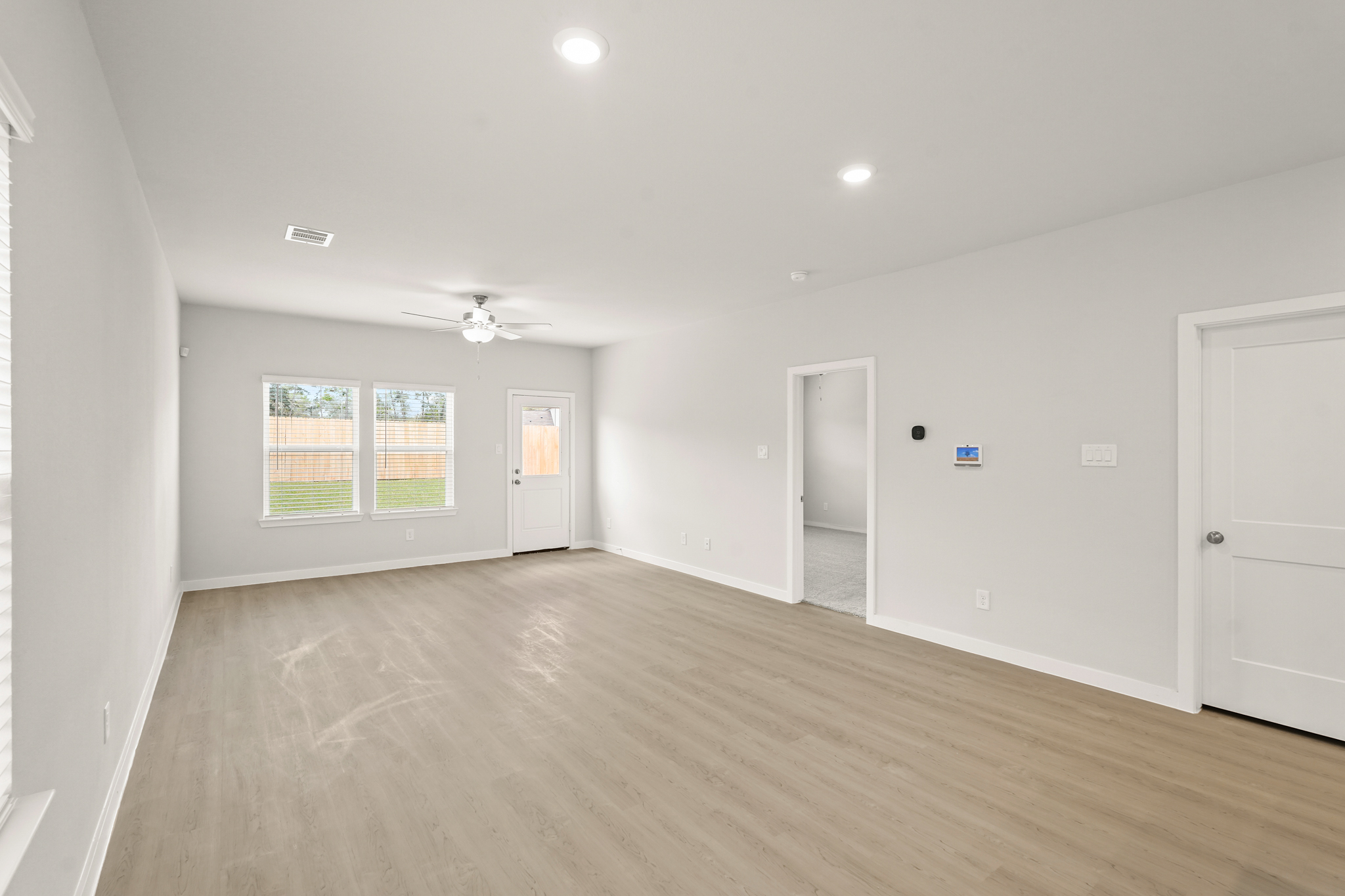 A room with a wood floor and white doors.