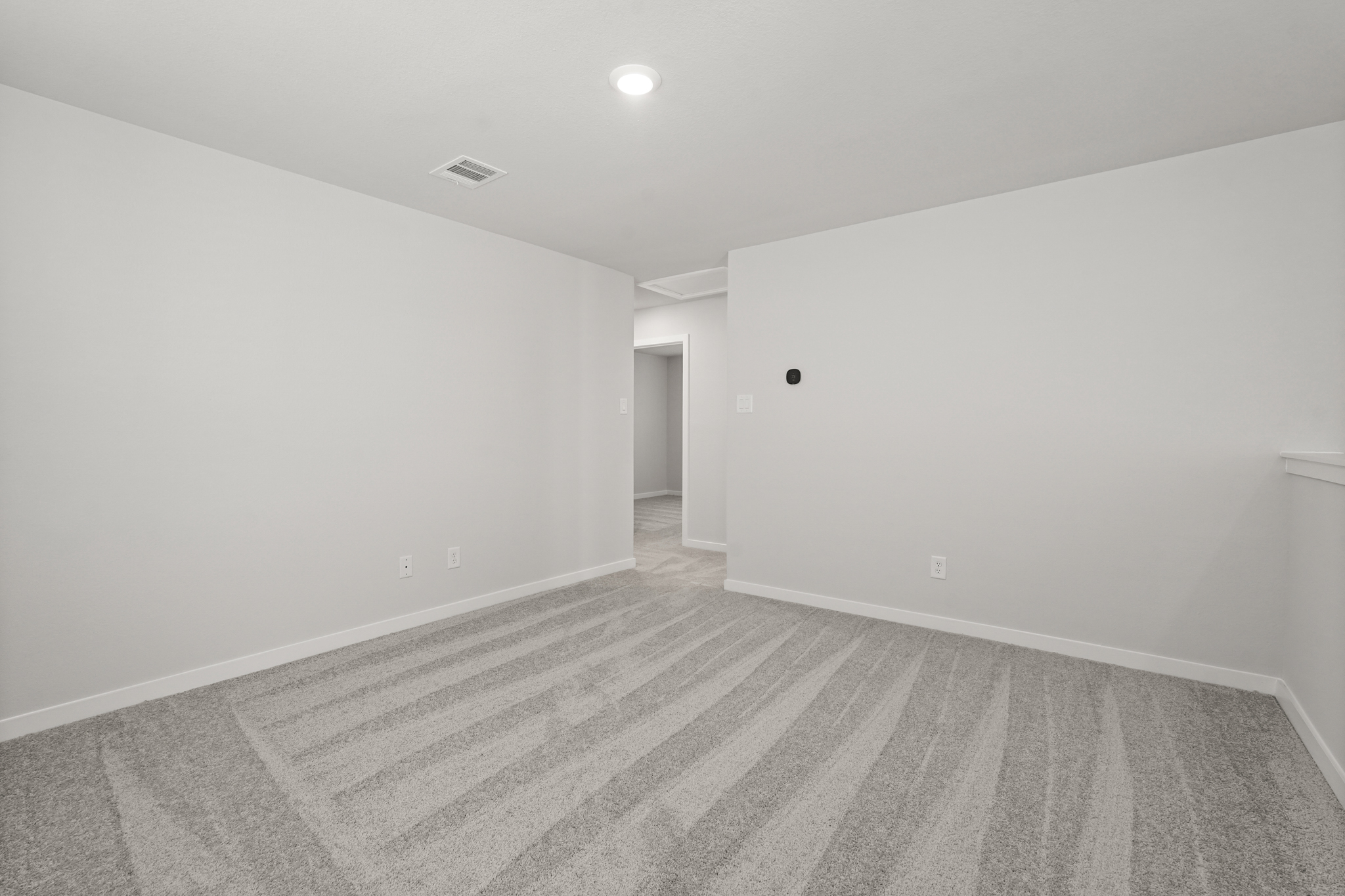 A hallway with a wood floor.