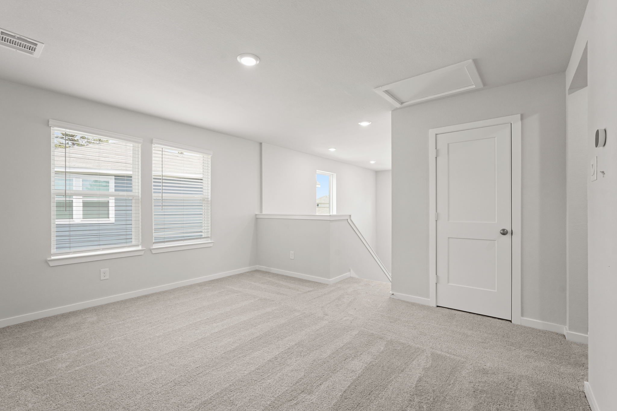 A room with white walls and a white door.