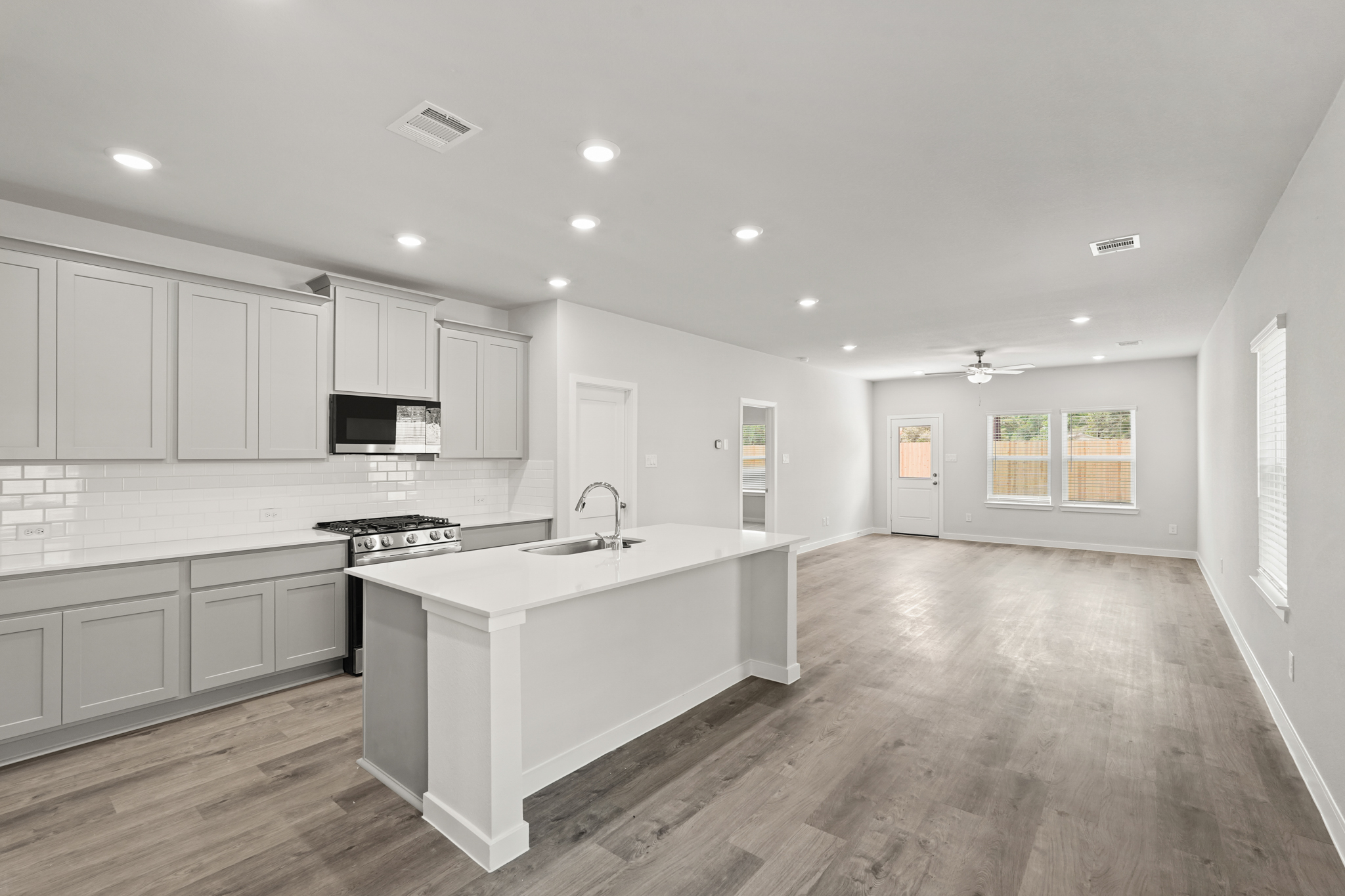 A kitchen with white cabinets.