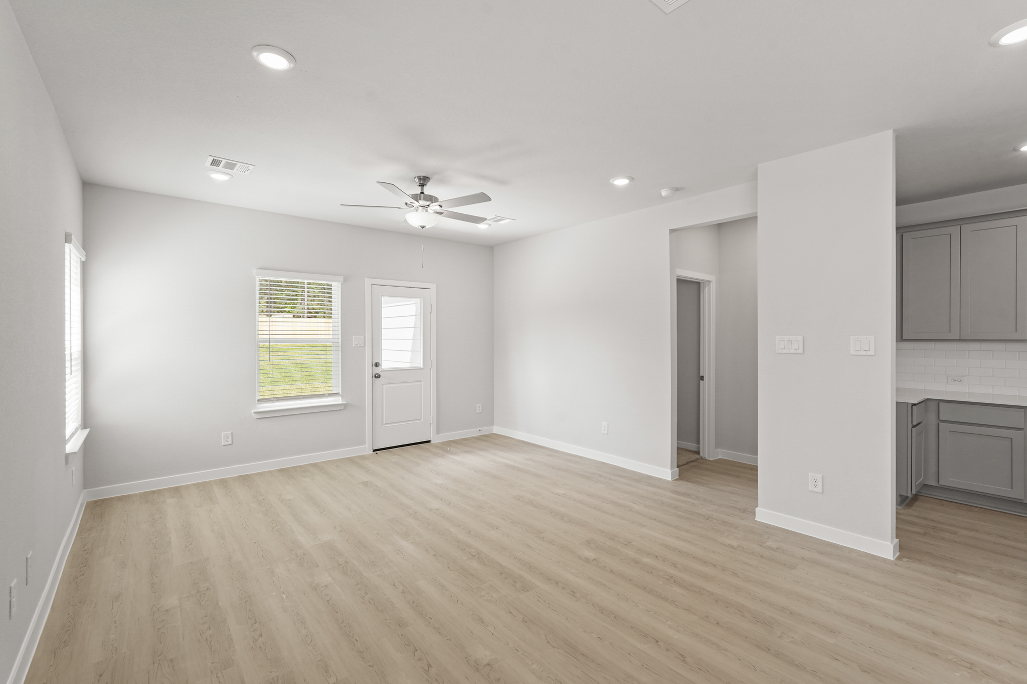 A room with white walls and a wood floor.