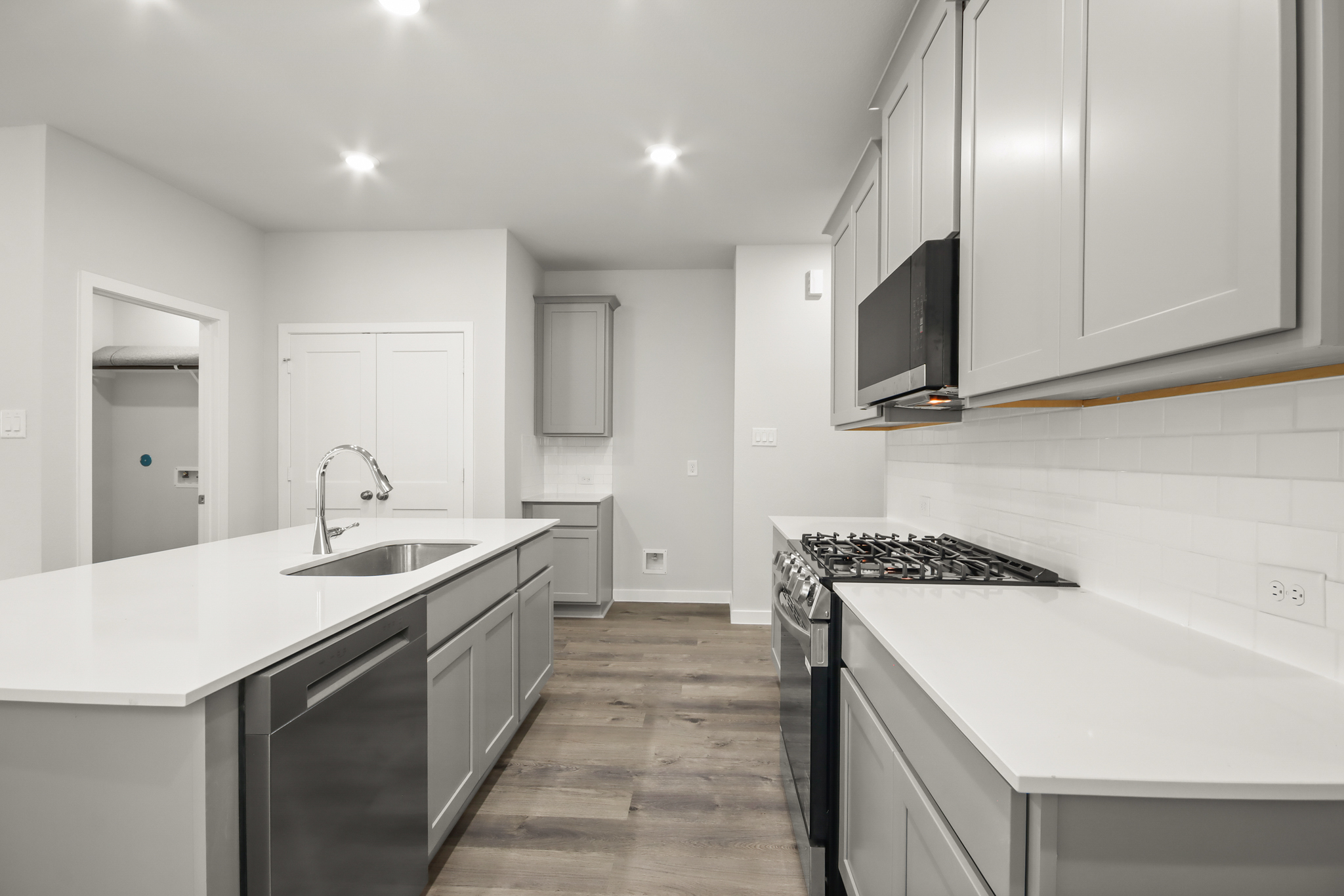 A kitchen with white cabinets.