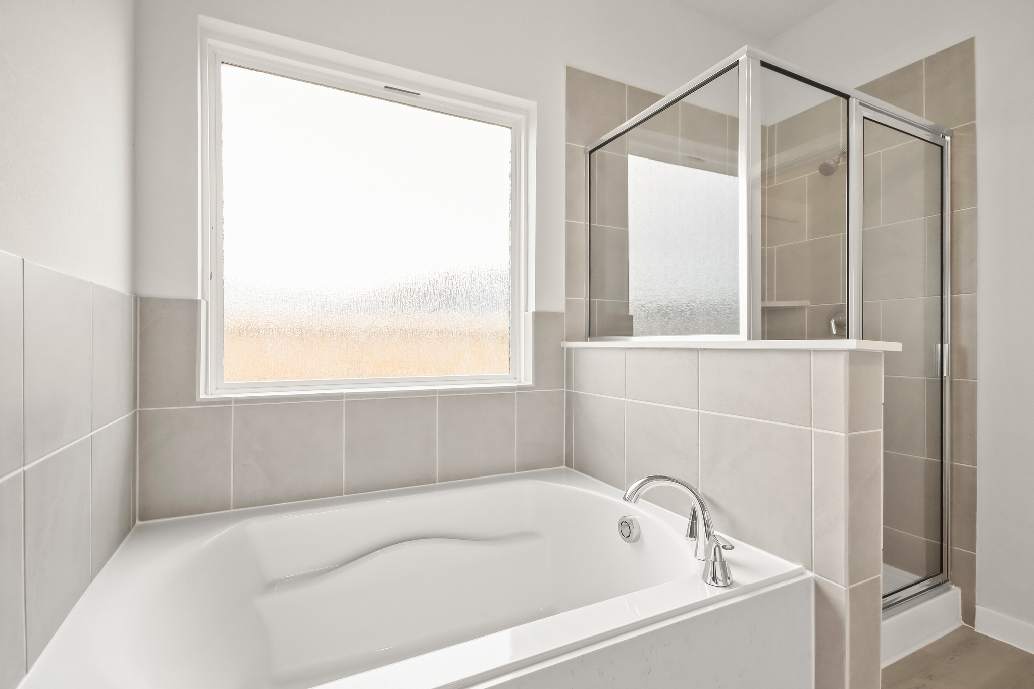 A bathroom with a tub and a window.