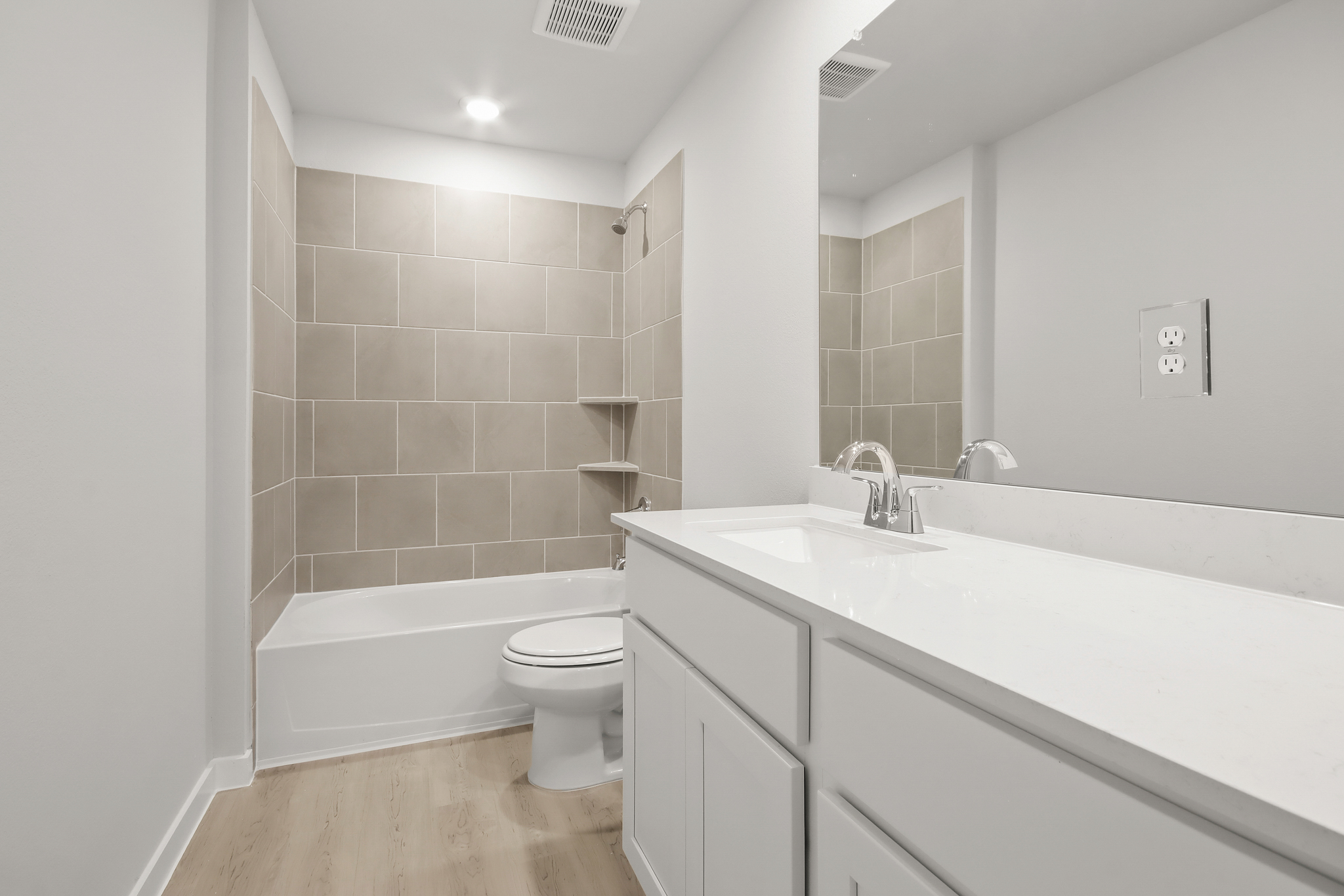 A bathroom with a tub sink and toilet.