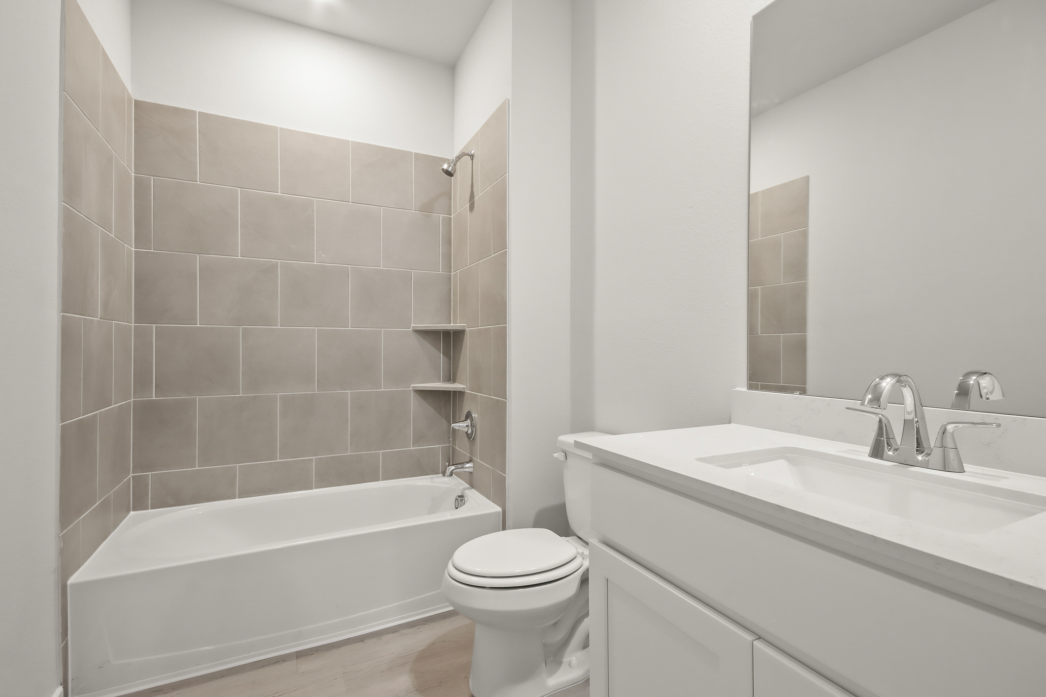 A bathroom with a tub toilet and sink.