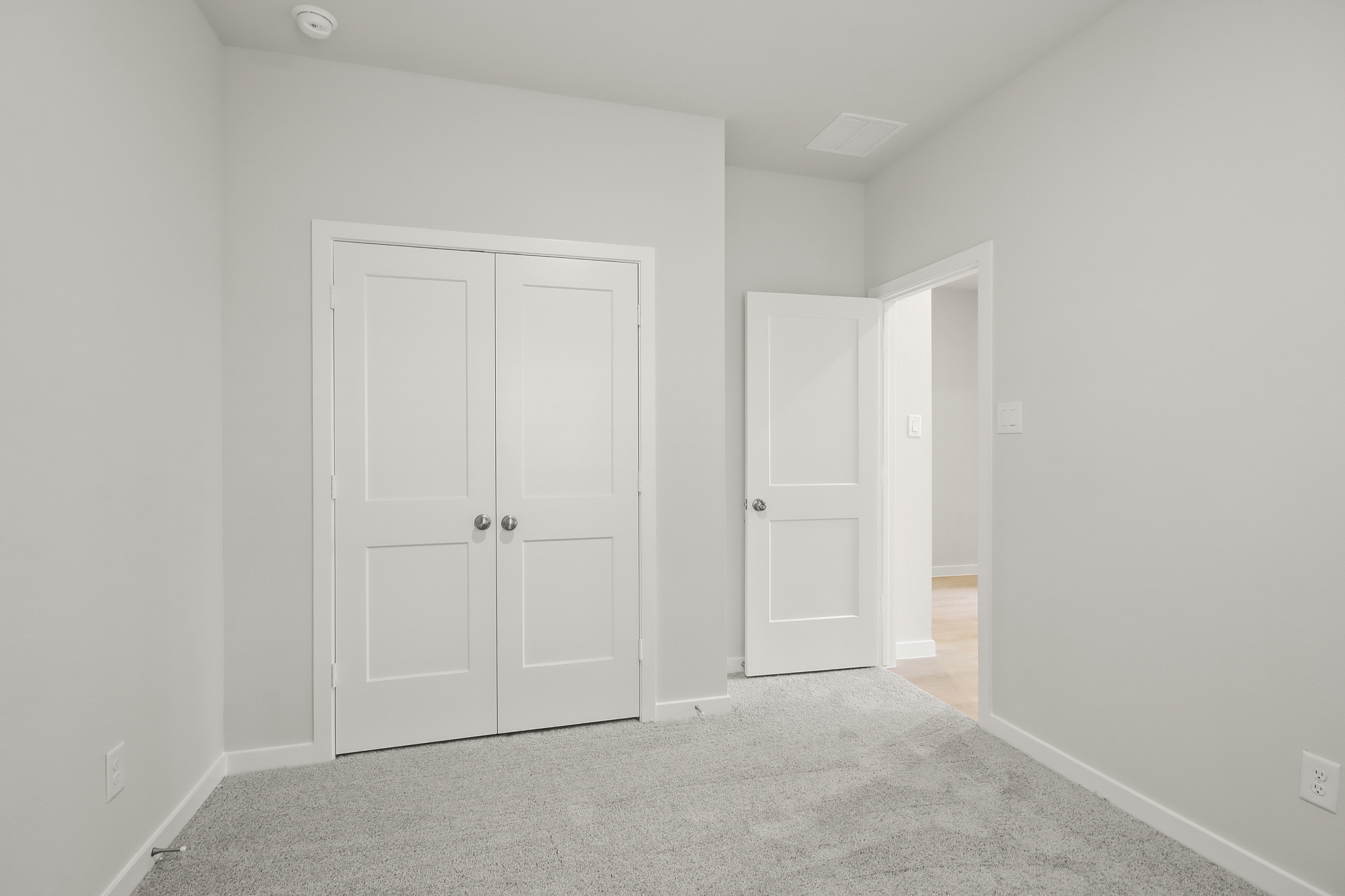 A hallway with white doors.