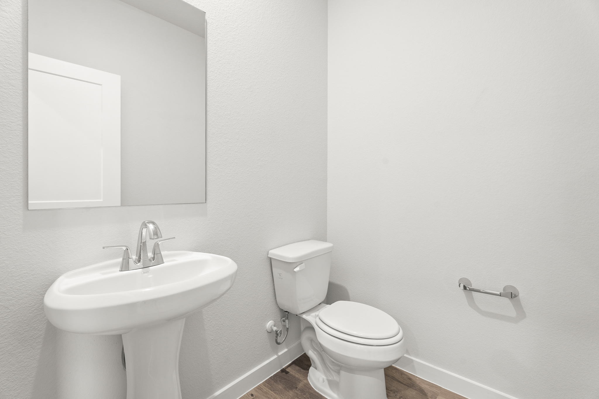 A bathroom with a toilet and sink.