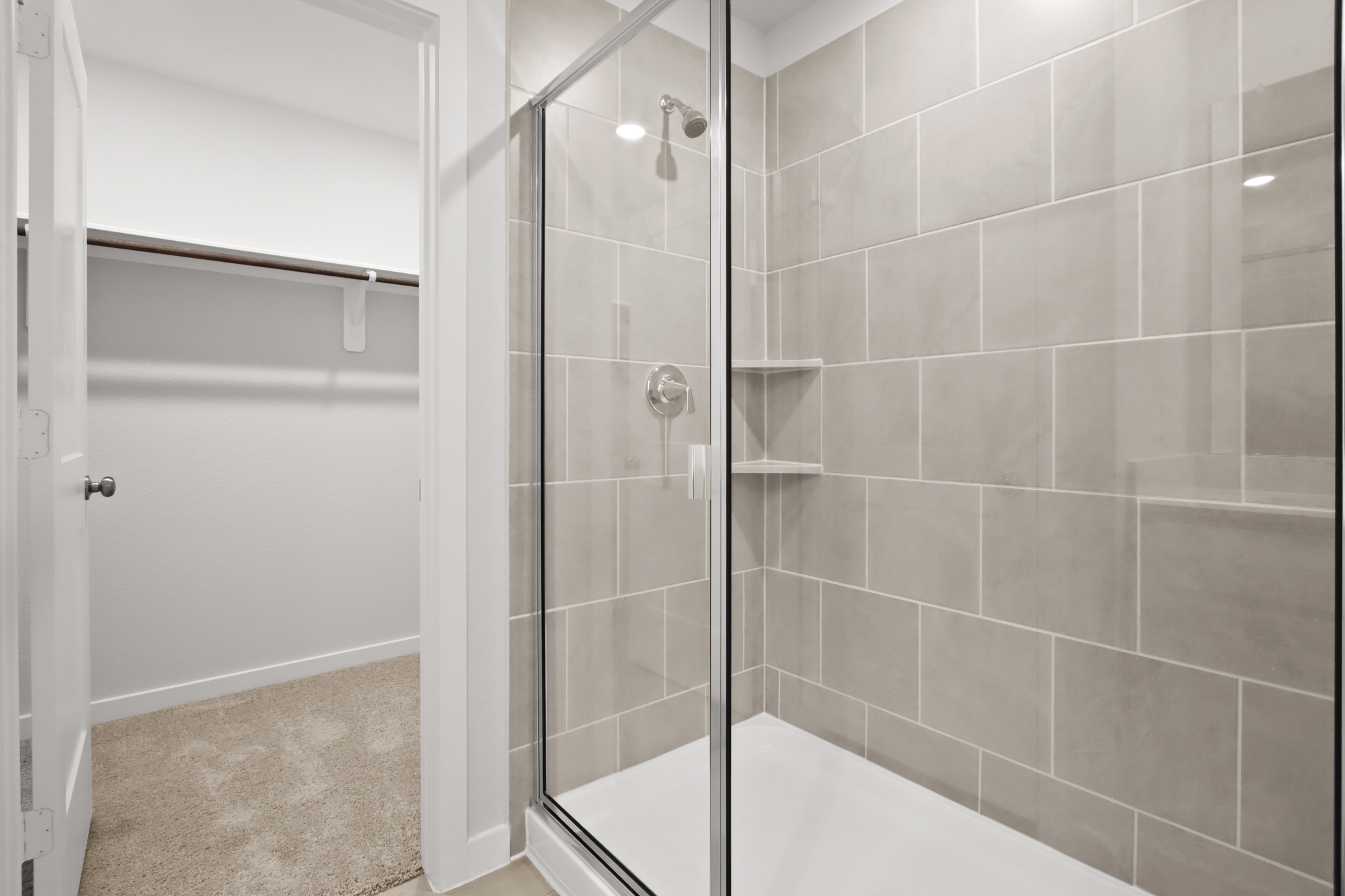 A shower with a glass door.