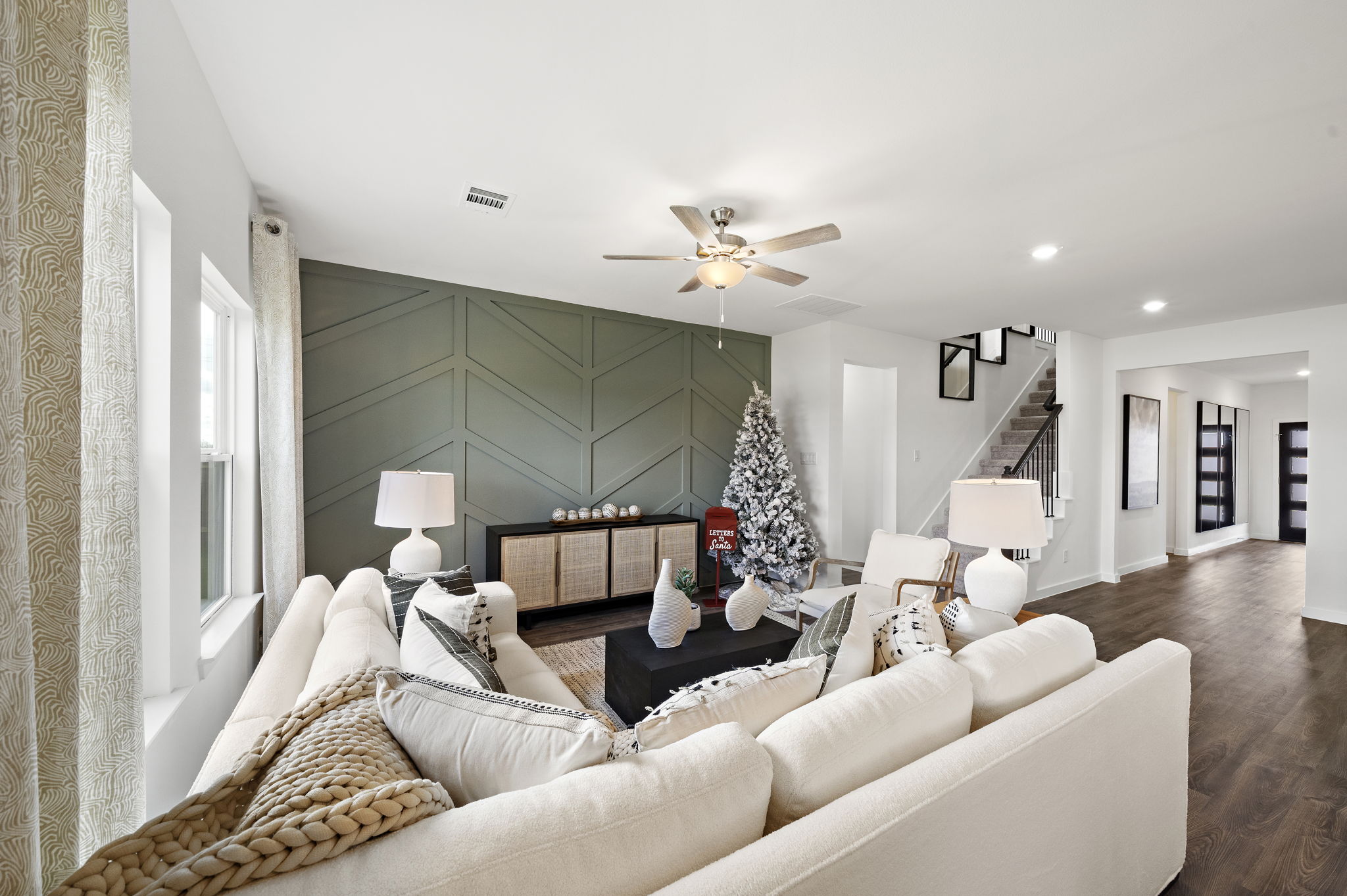 A living room with a couch and a chandelier.