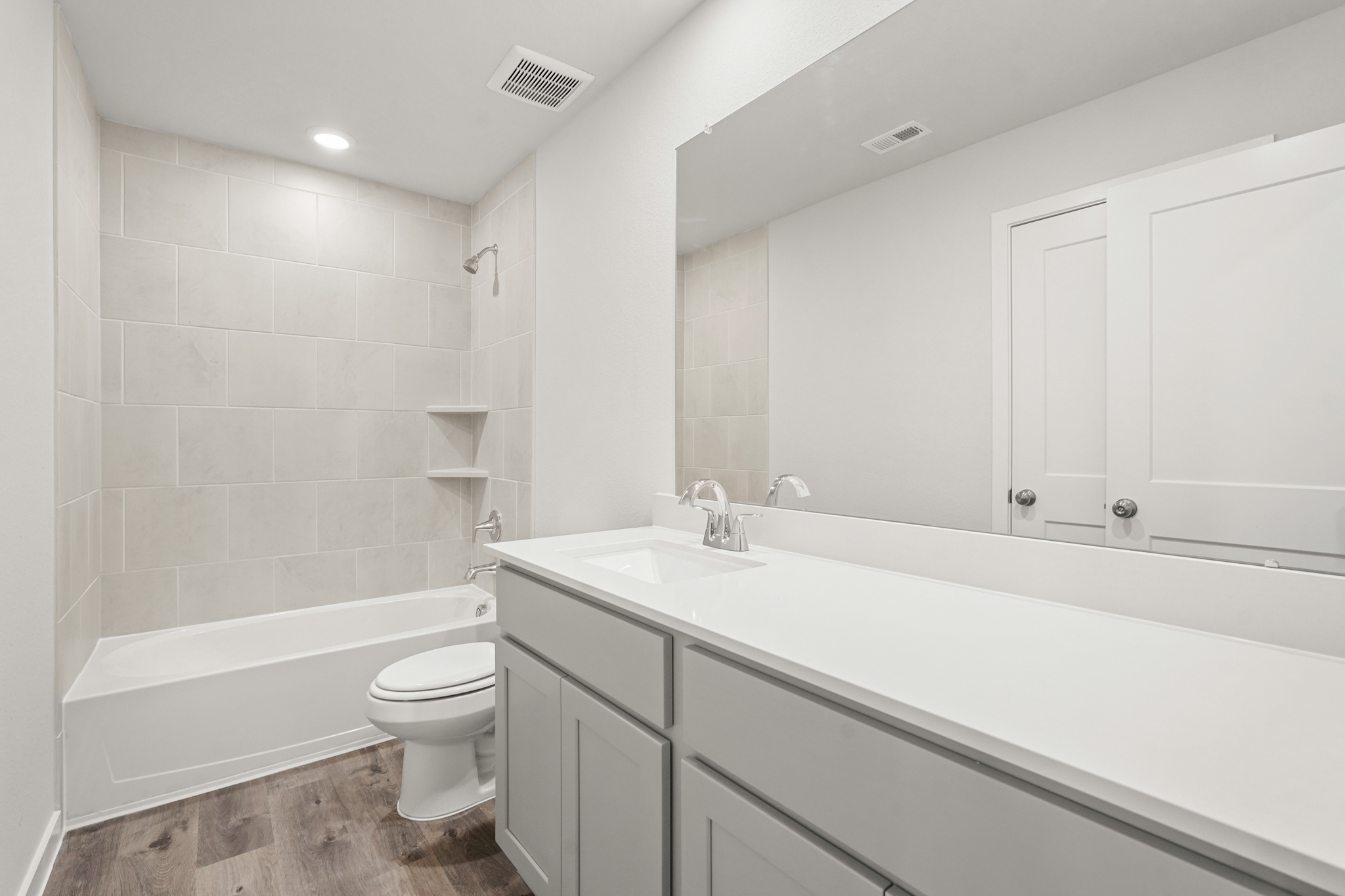 A bathroom with a tub toilet and sink.