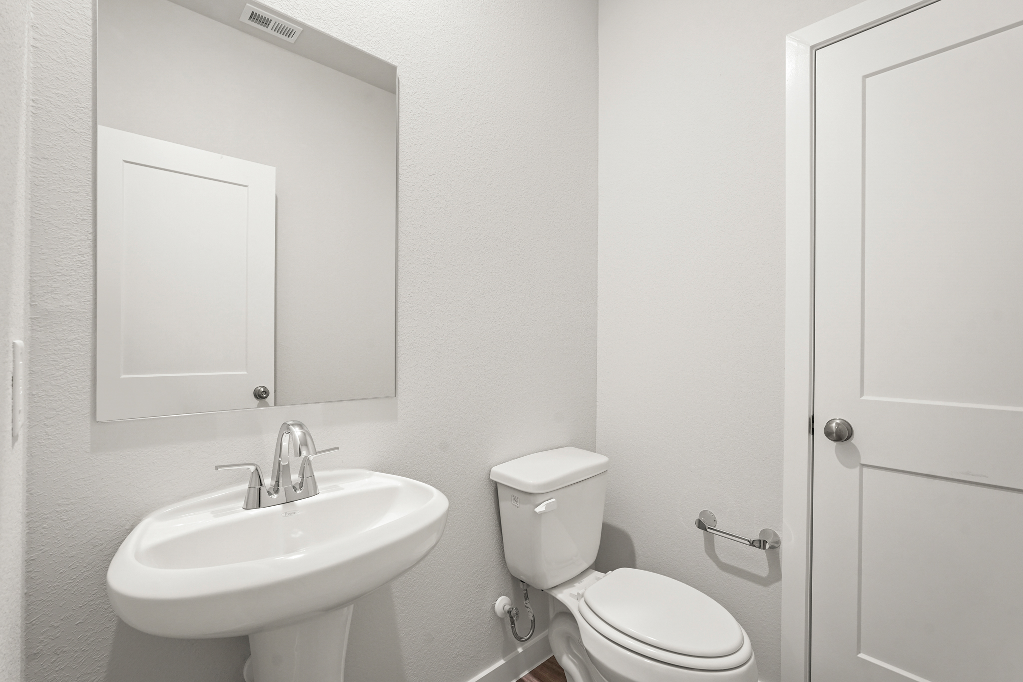 A bathroom with a toilet and sink.