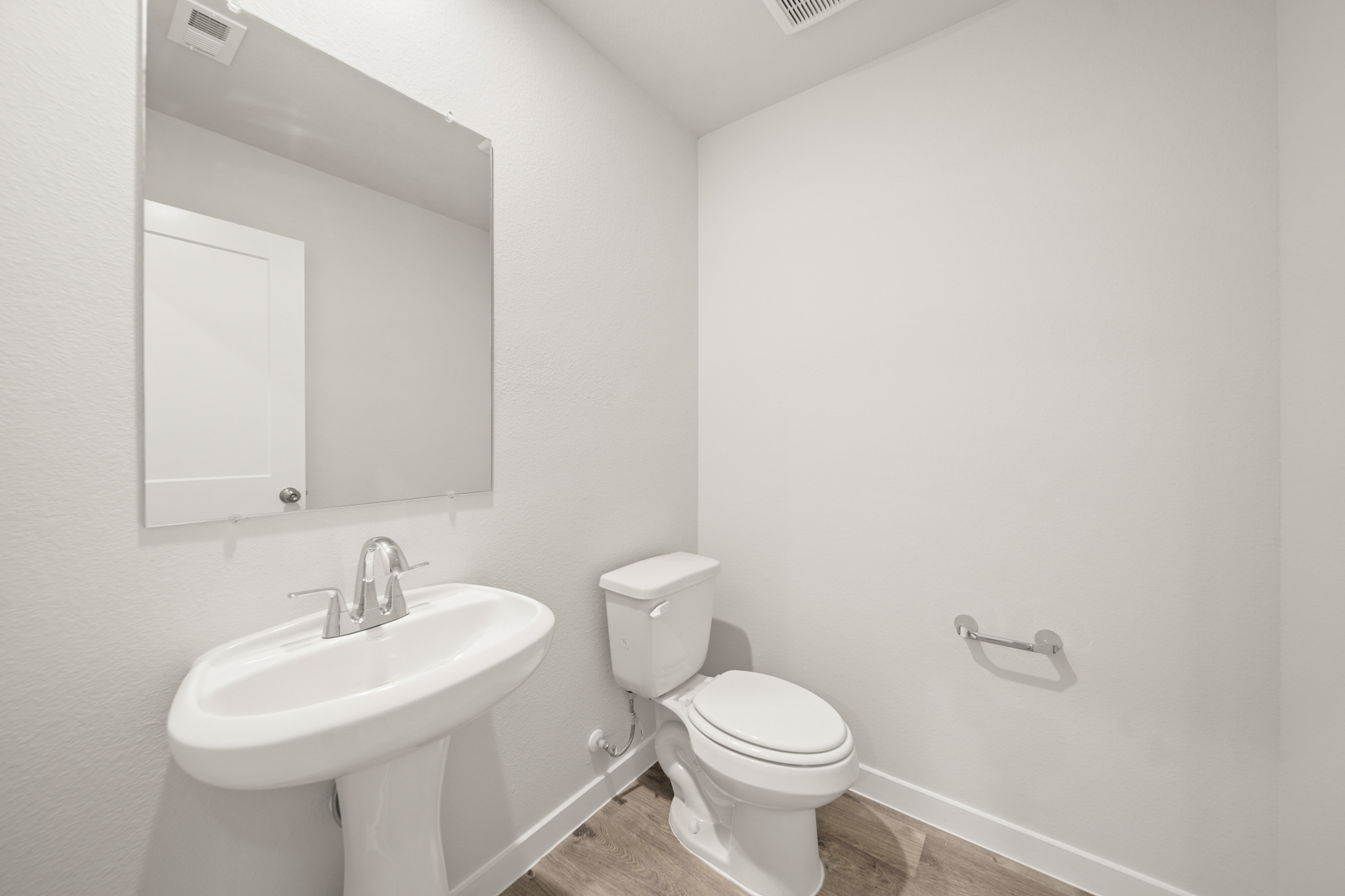 A bathroom with a toilet and sink.