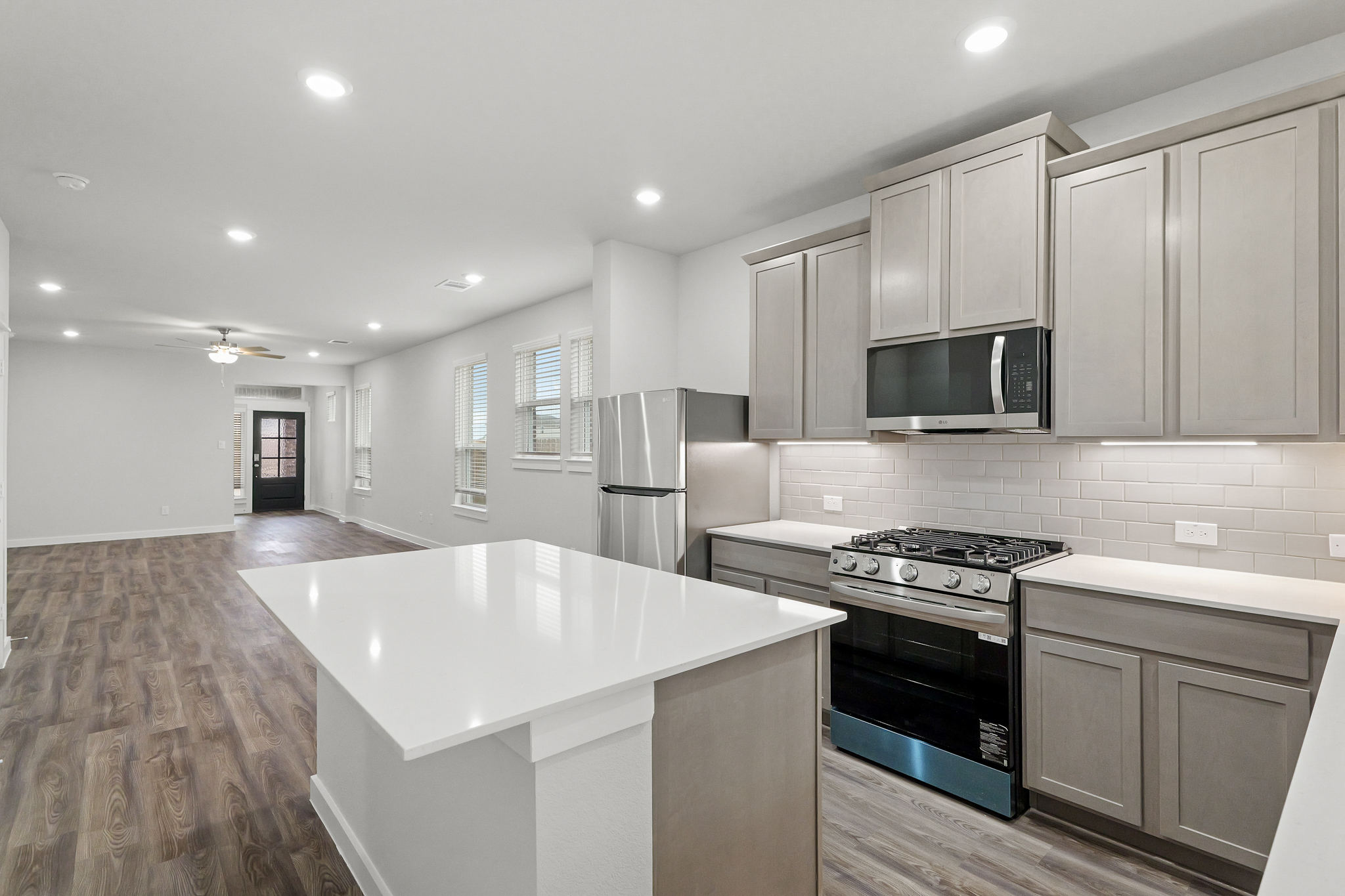A kitchen with white cabinets.