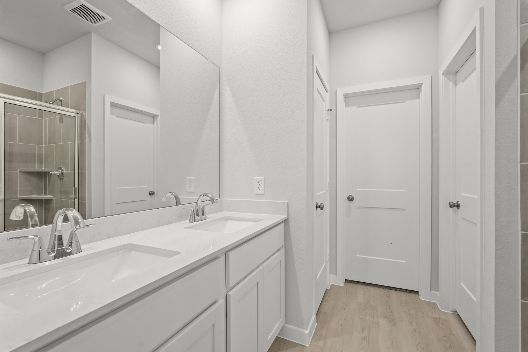 A bathroom with a large mirror.