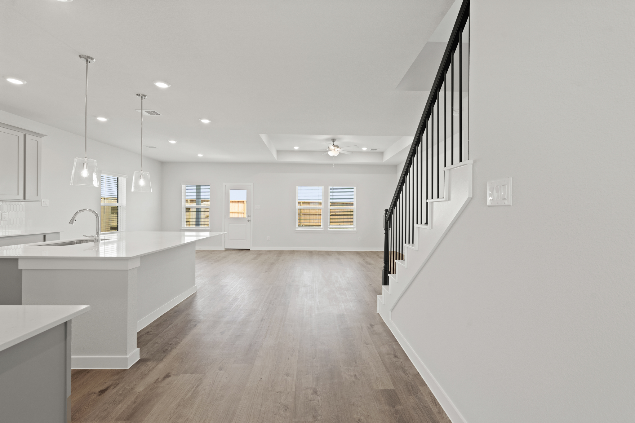 A large kitchen with white walls.