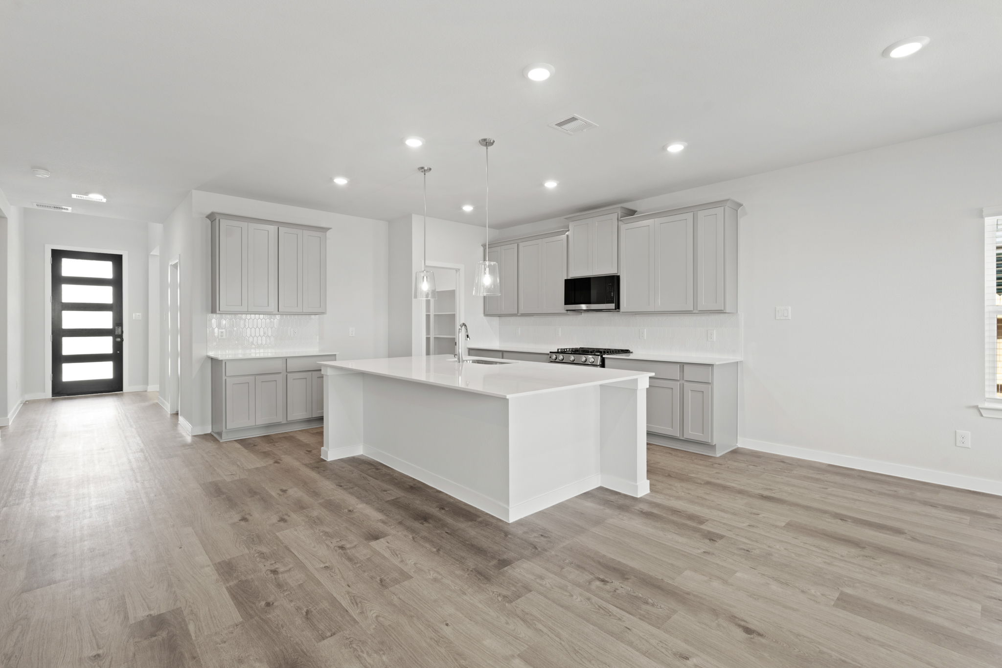 A kitchen with white cabinets.