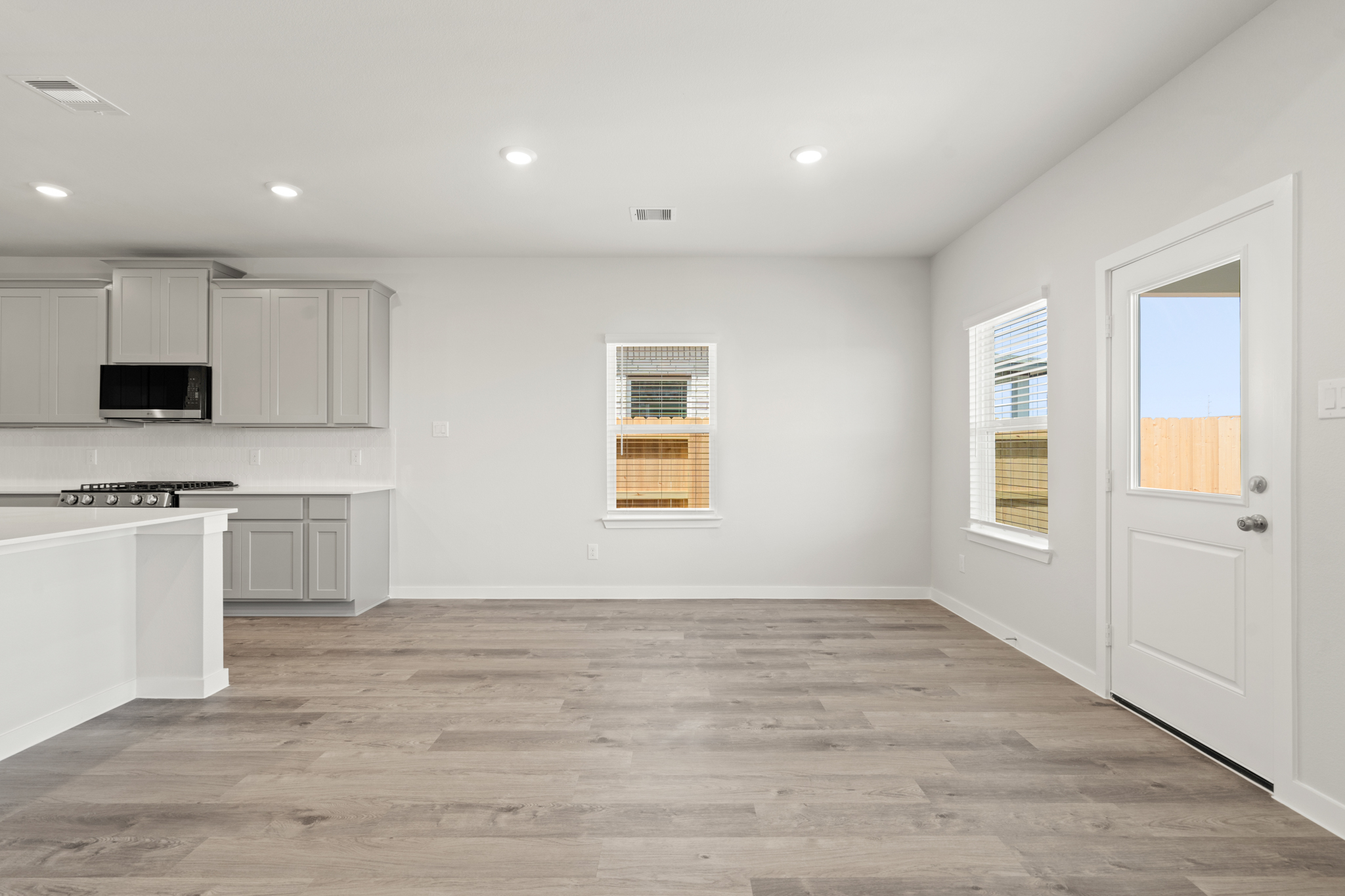 A kitchen with white cabinets.