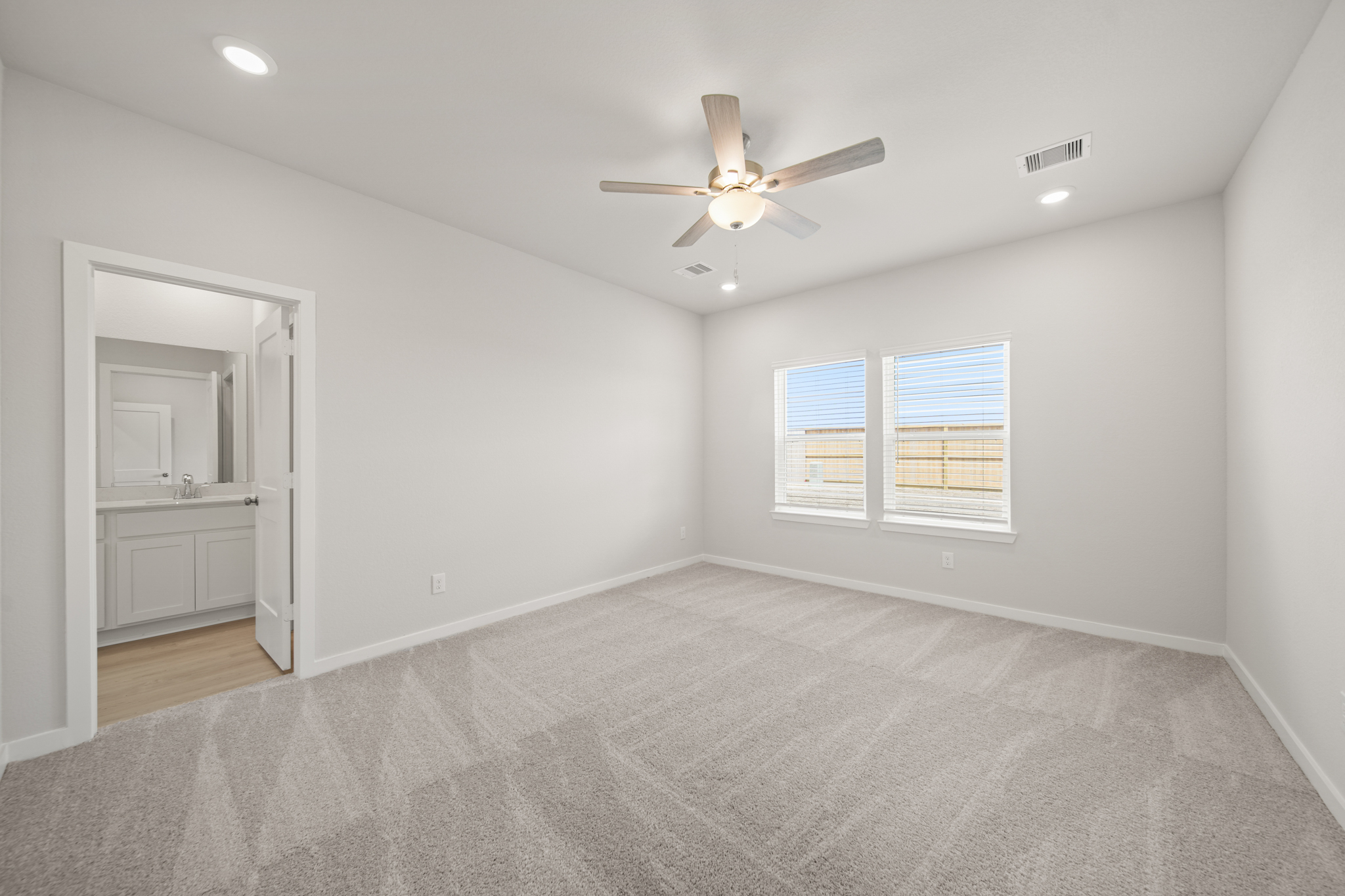 A room with a ceiling fan and a window.