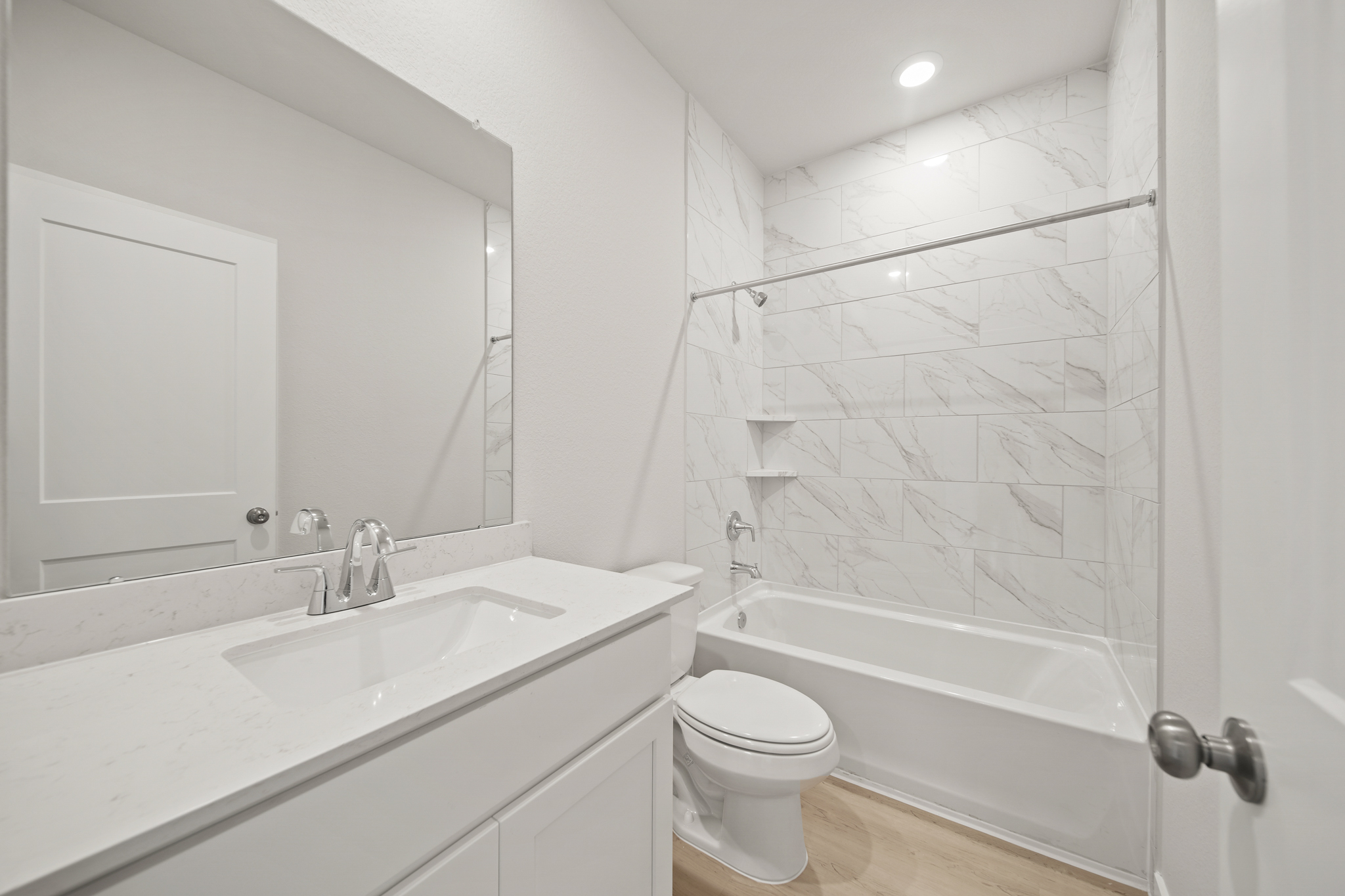 A bathroom with a tub sink and toilet.