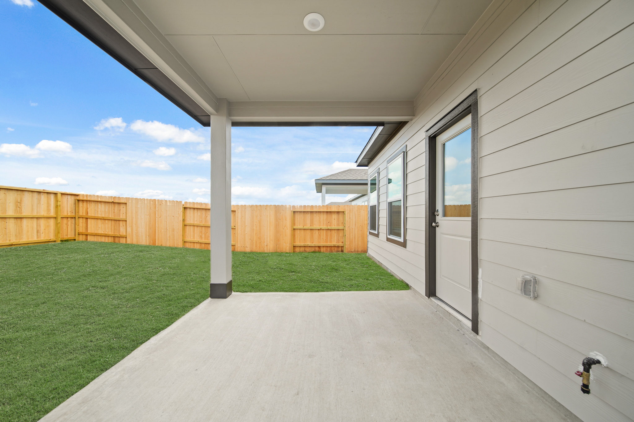 A house with a fence and grass.