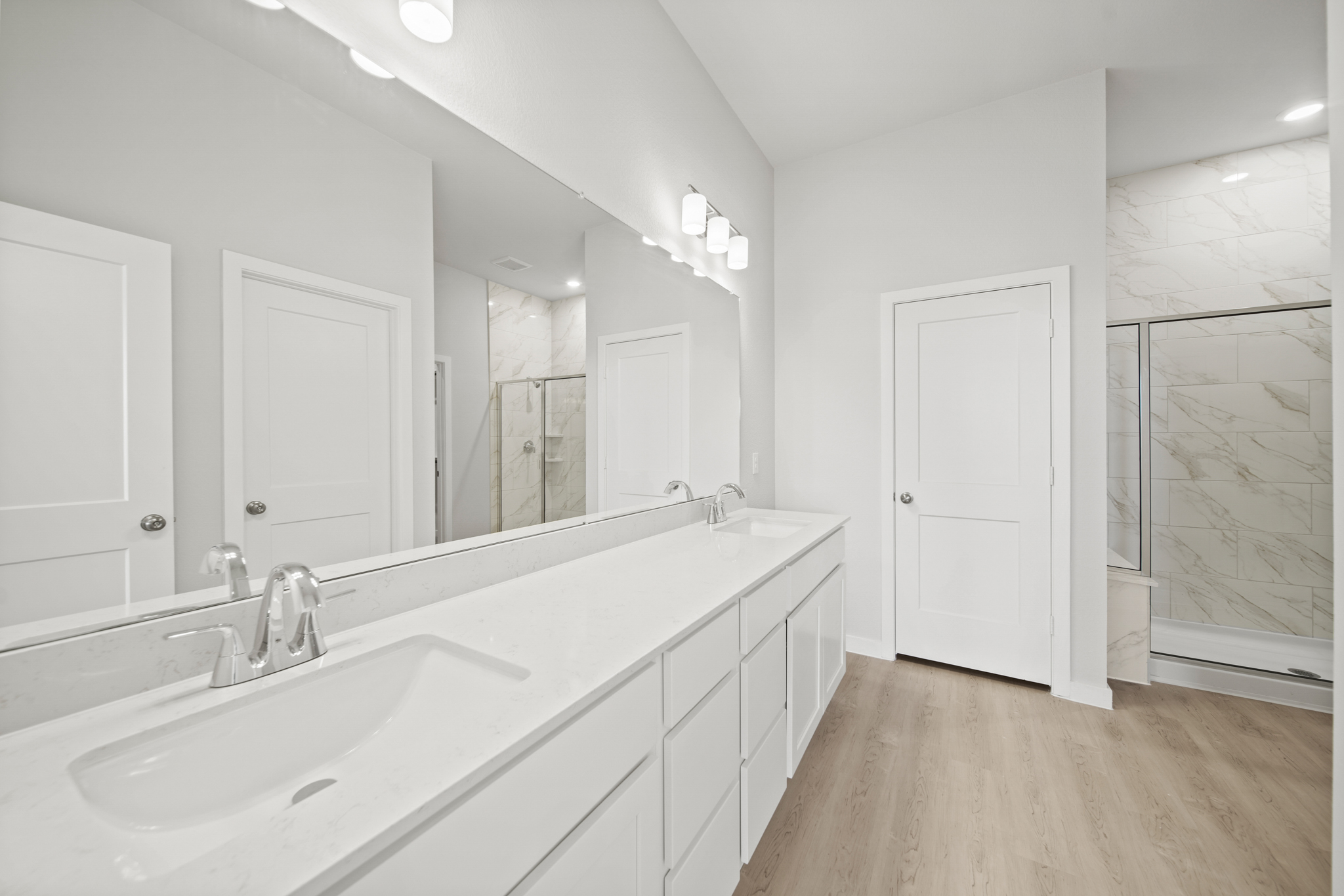 A bathroom with a large mirror.