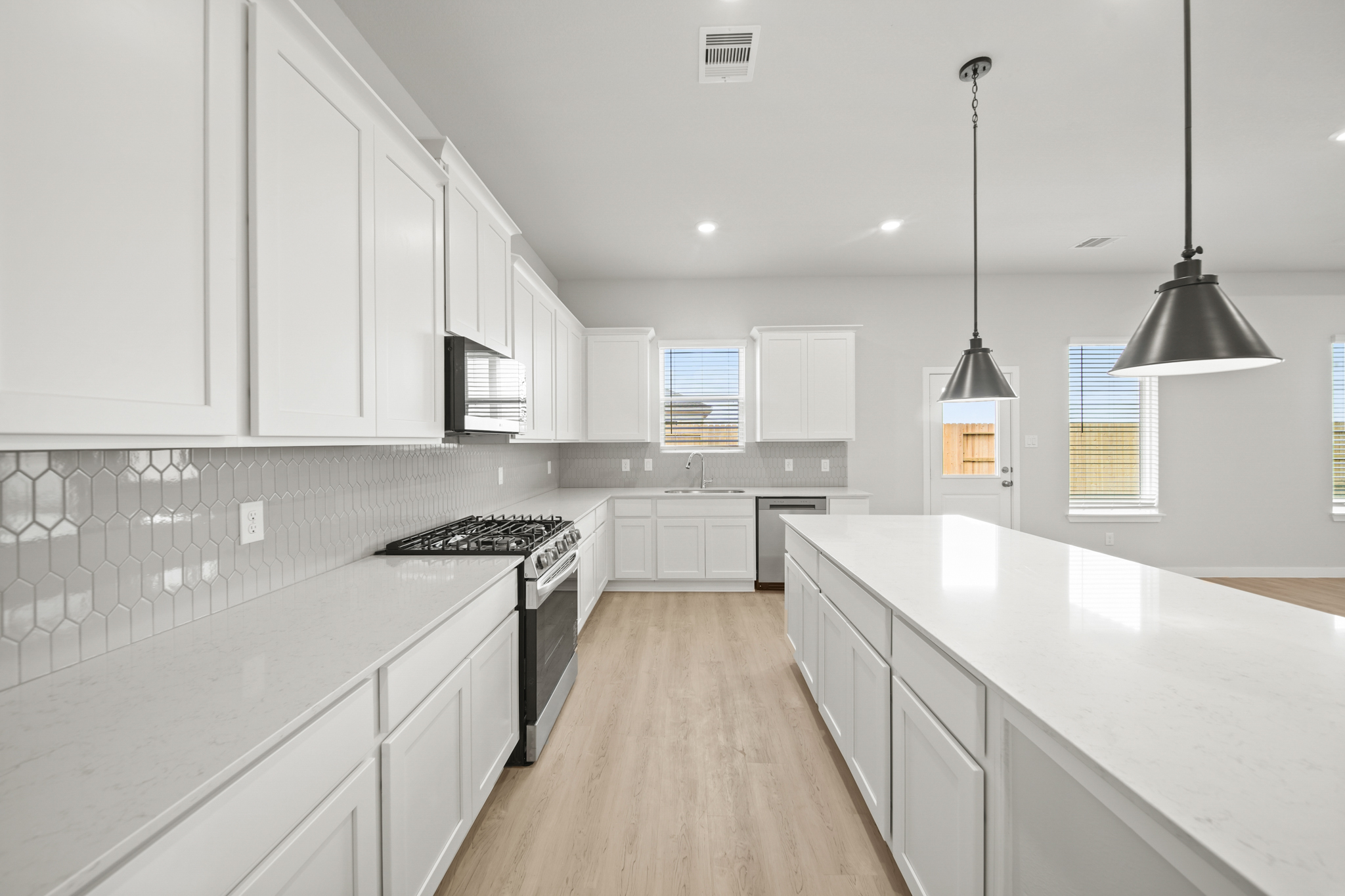 A kitchen with white cabinets.